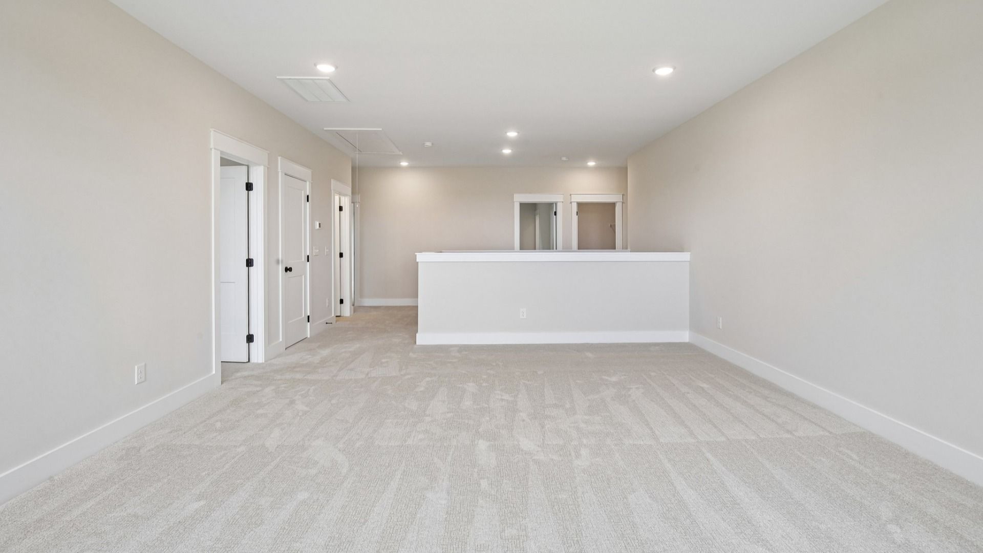 Loft area with carpet and access to bedrooms