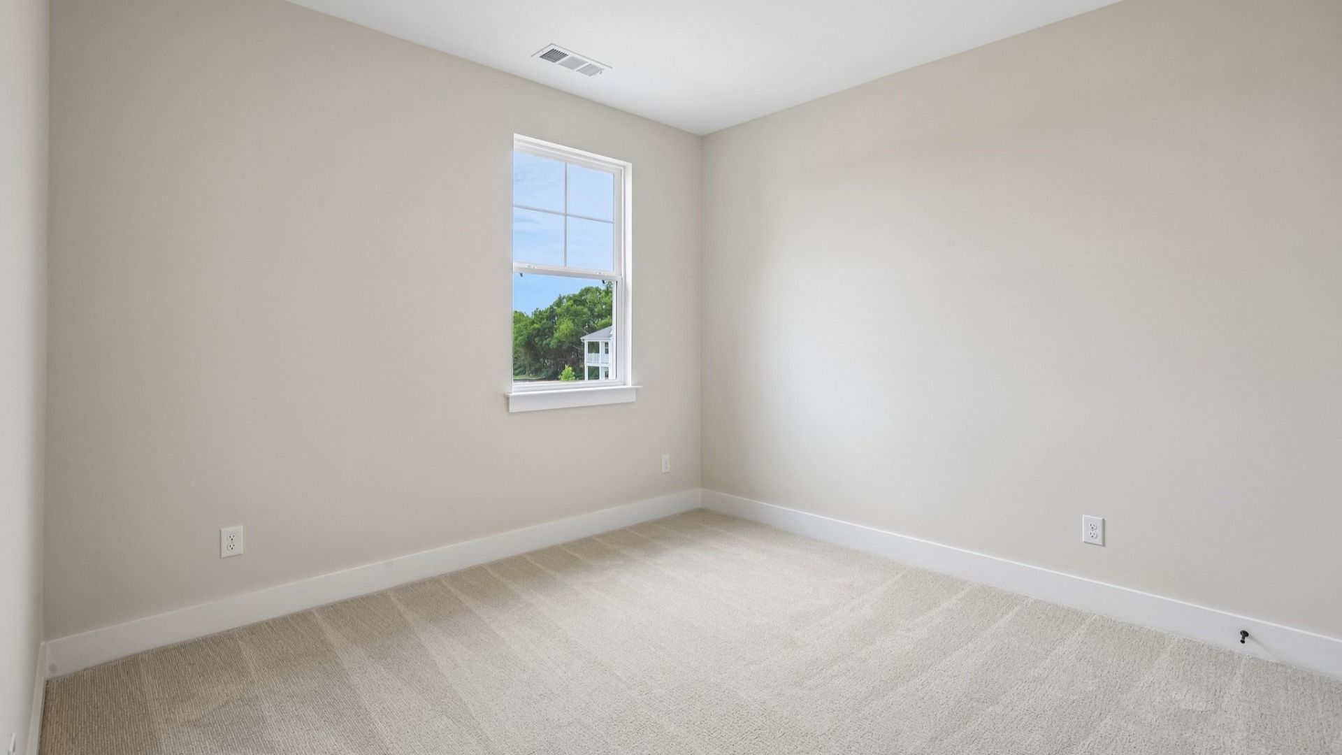 Bedroom with carpet and window