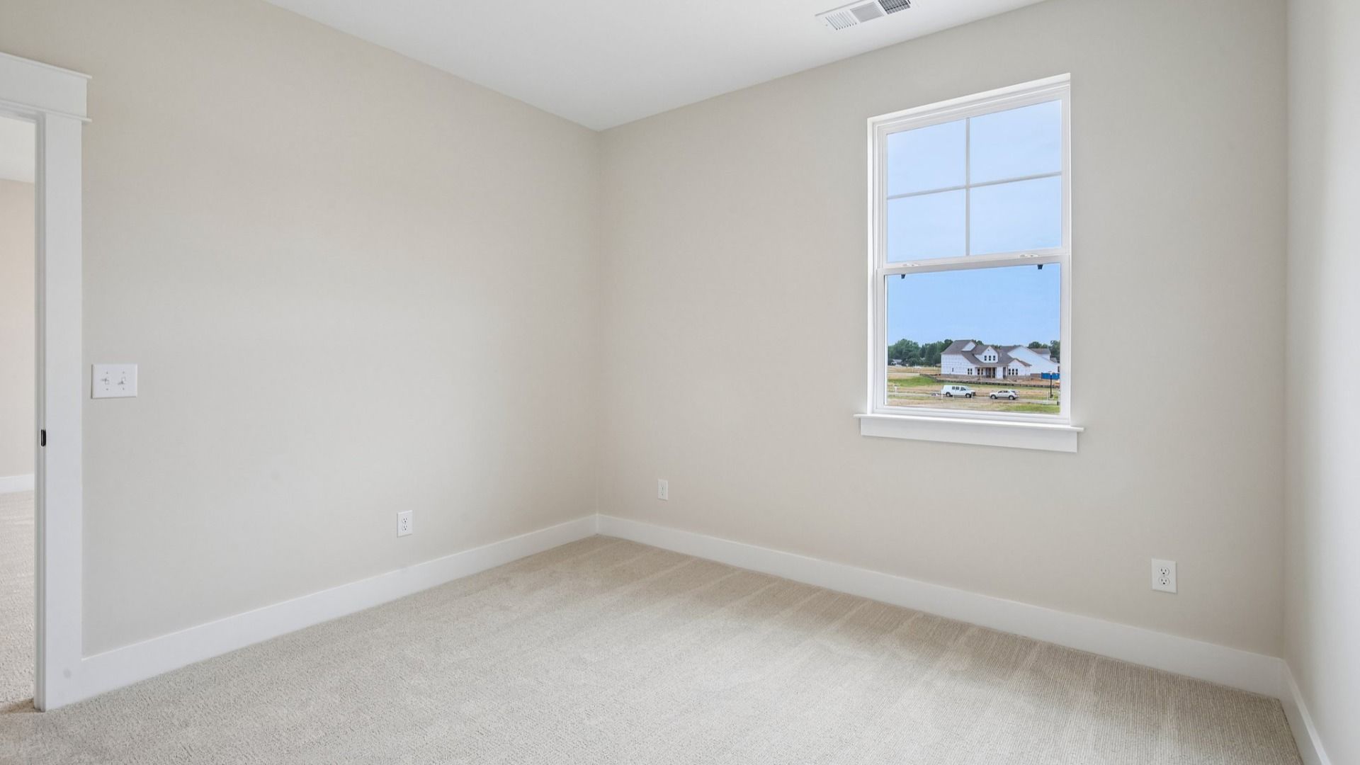 Bedroom with carpet and window