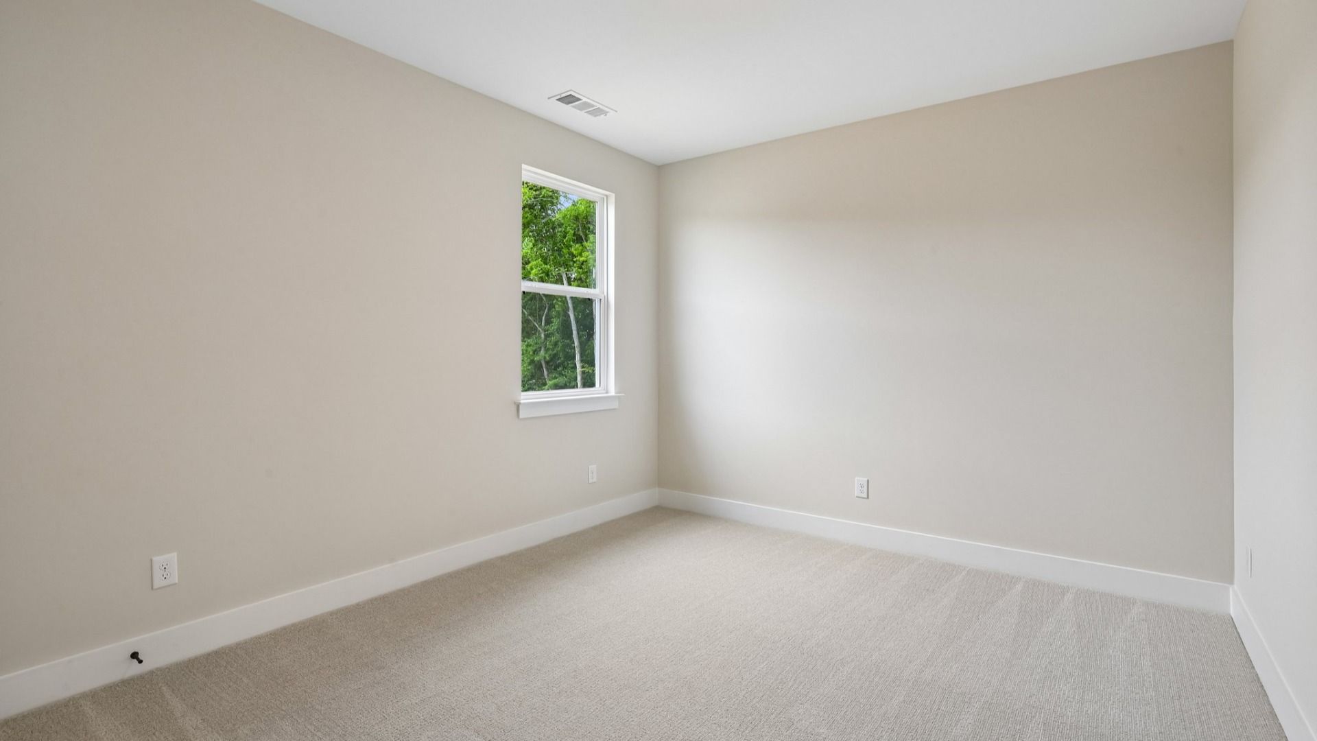 Bedroom with carpet and window