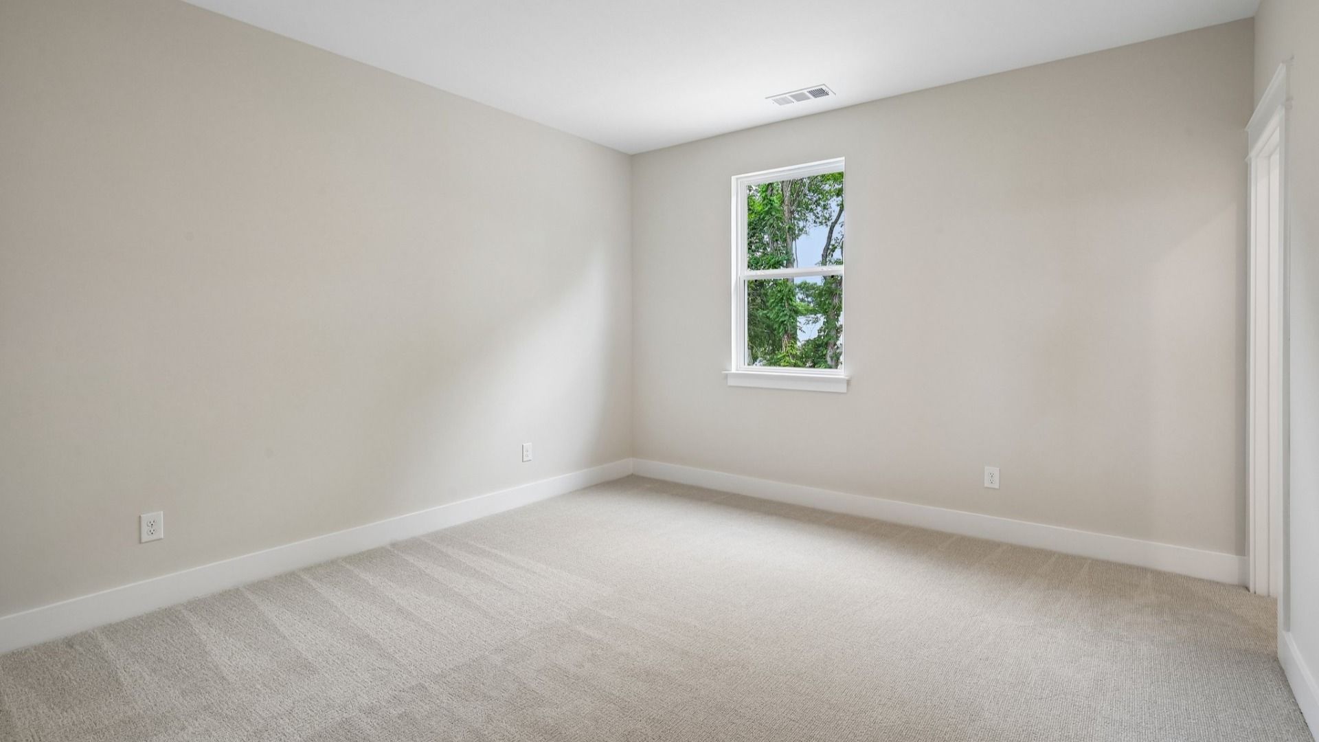 Bedroom with carpet and window