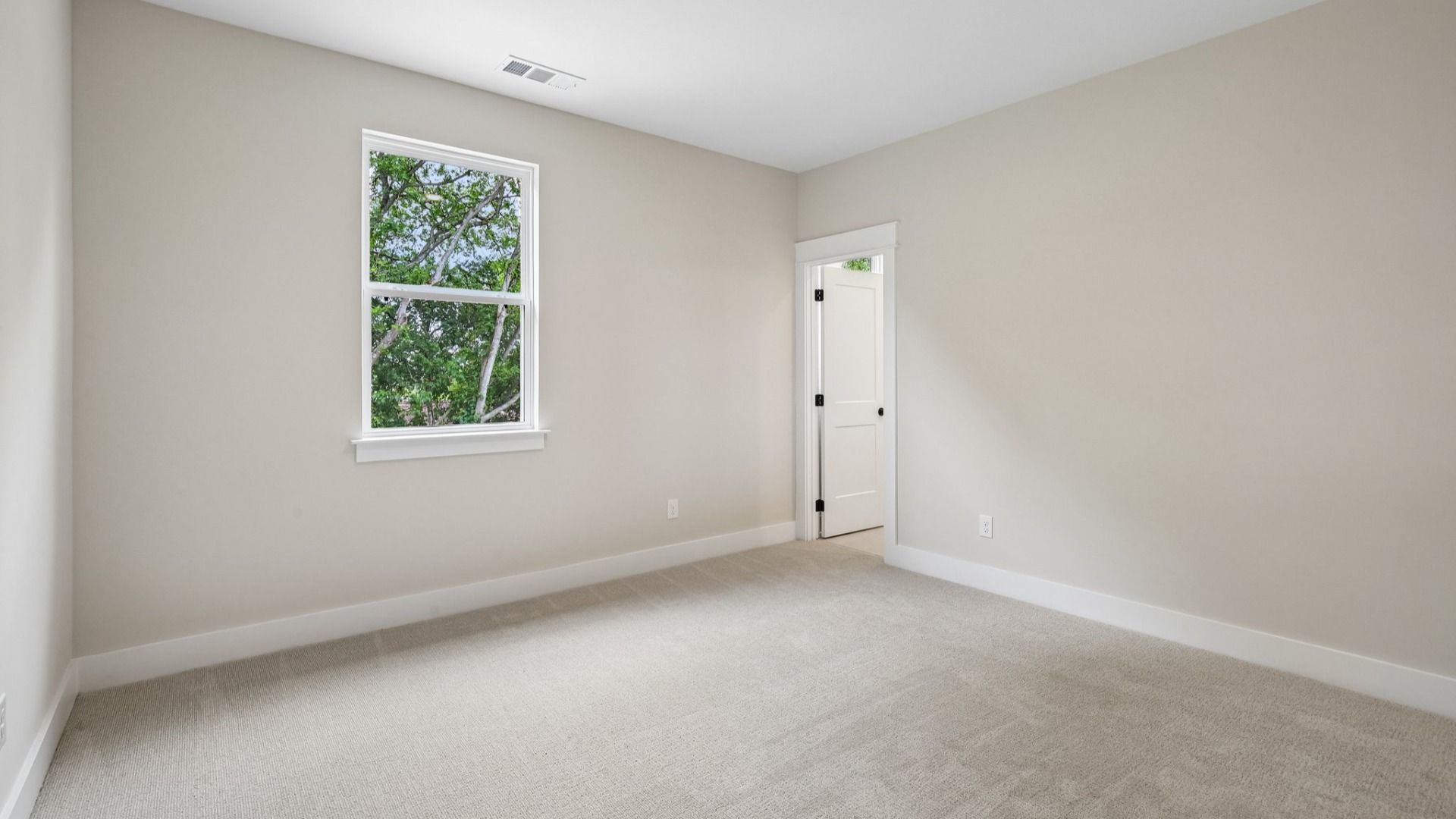Bedroom with carpet and window