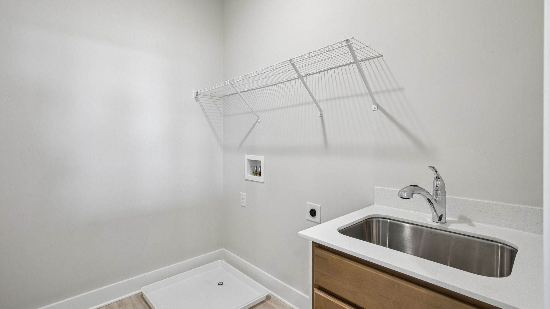 Dedicated laundry room with ventilated shelf