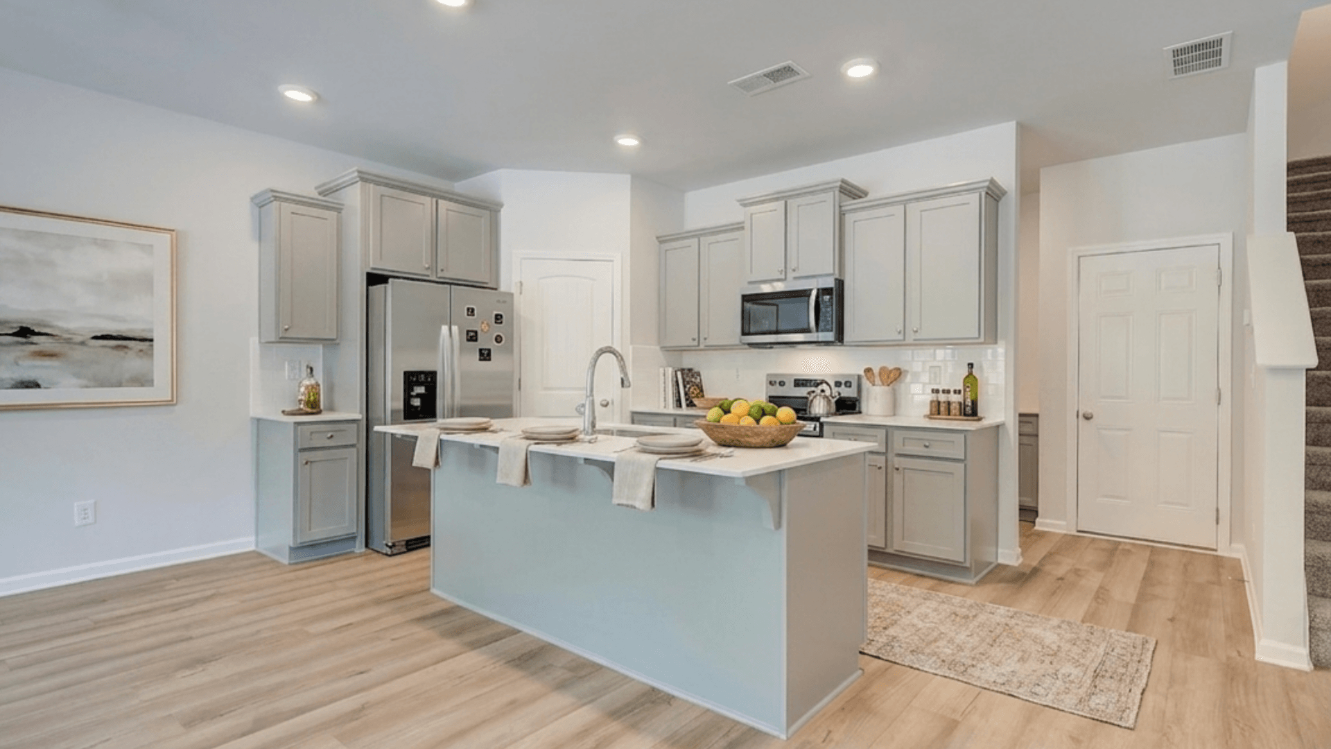Kitchen with quartz countertops, tile backsplash, and hard surface flooring