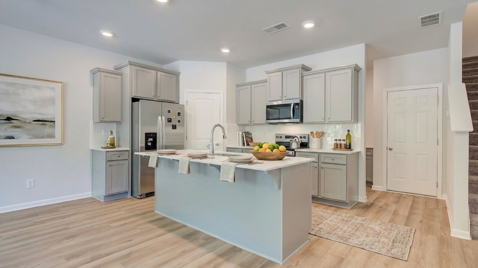 Kitchen with quartz countertops, tile backsplash, and hard surface flooring