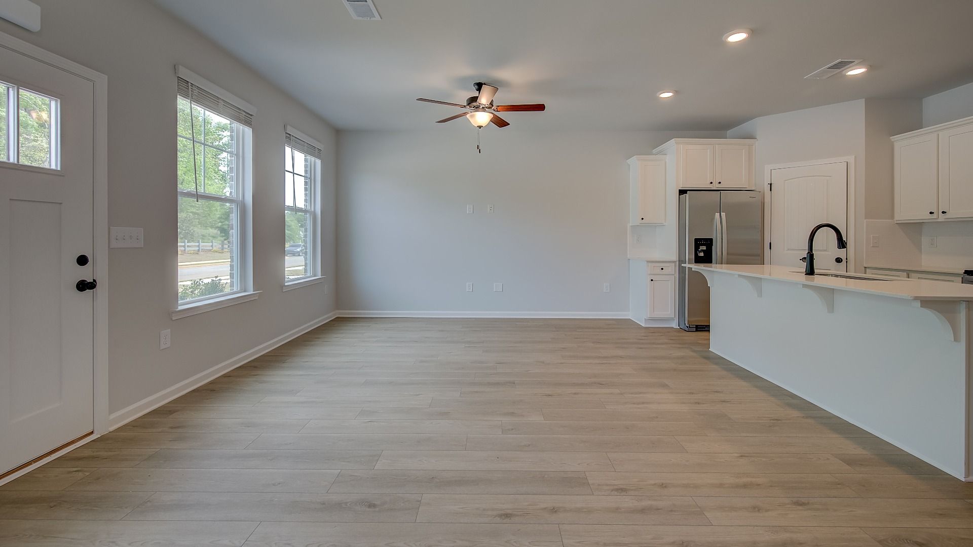 Gathering room with ceiling fan and hard surface flooring