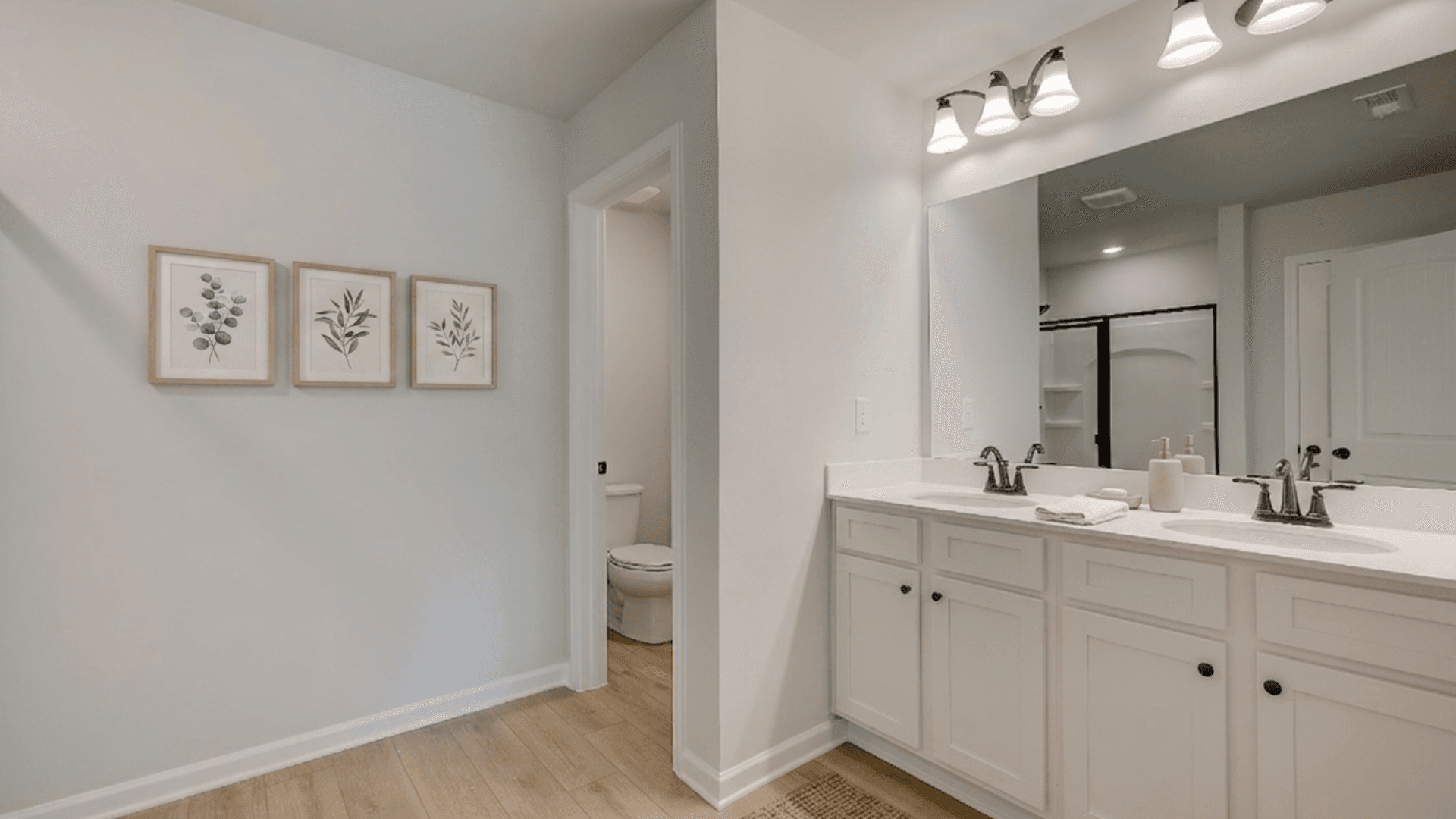 Bathroom with dual vanity and separate area for toilet