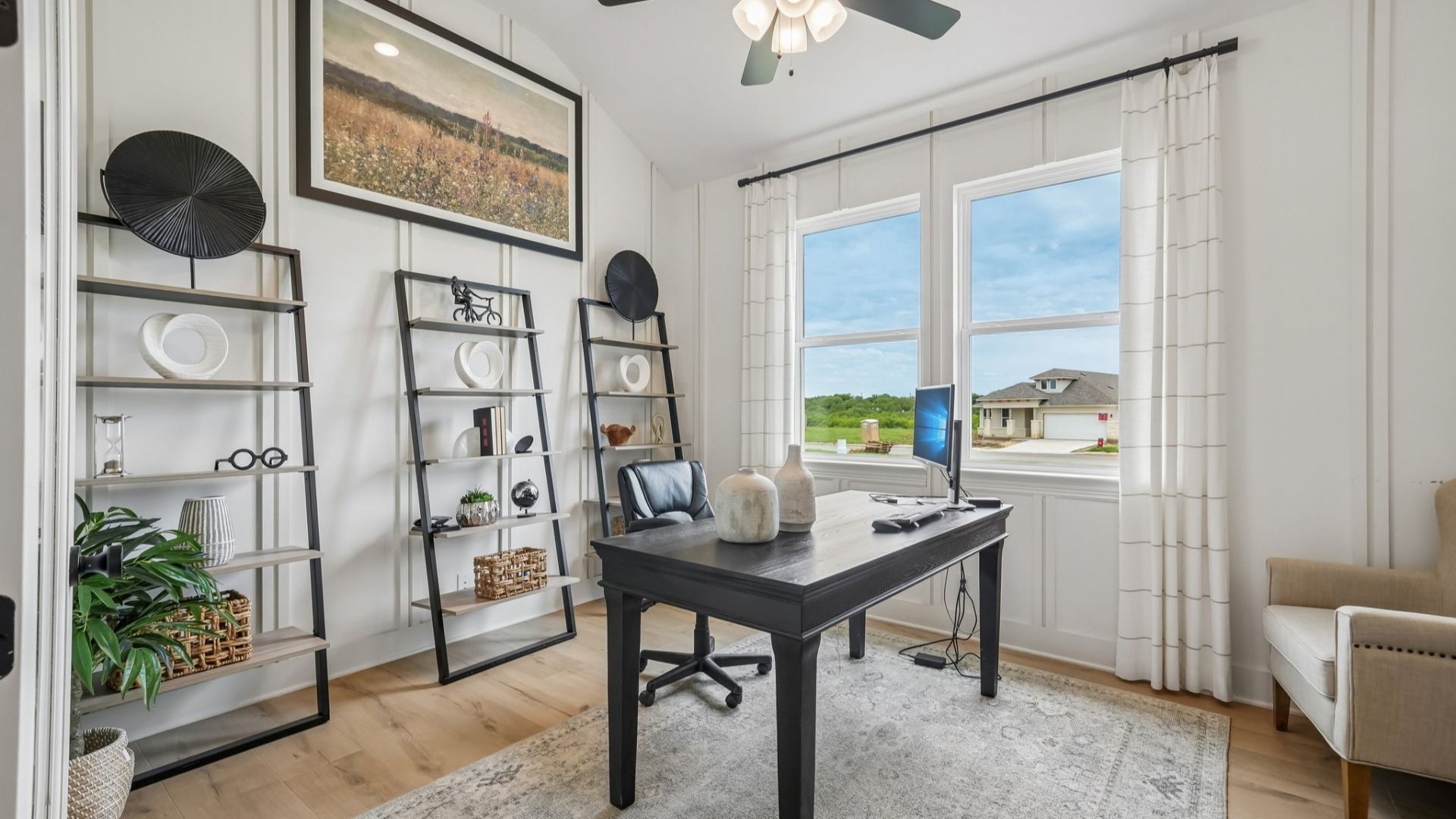 Dedicated home office with custom woodwork wall treatment and elegant workspace design