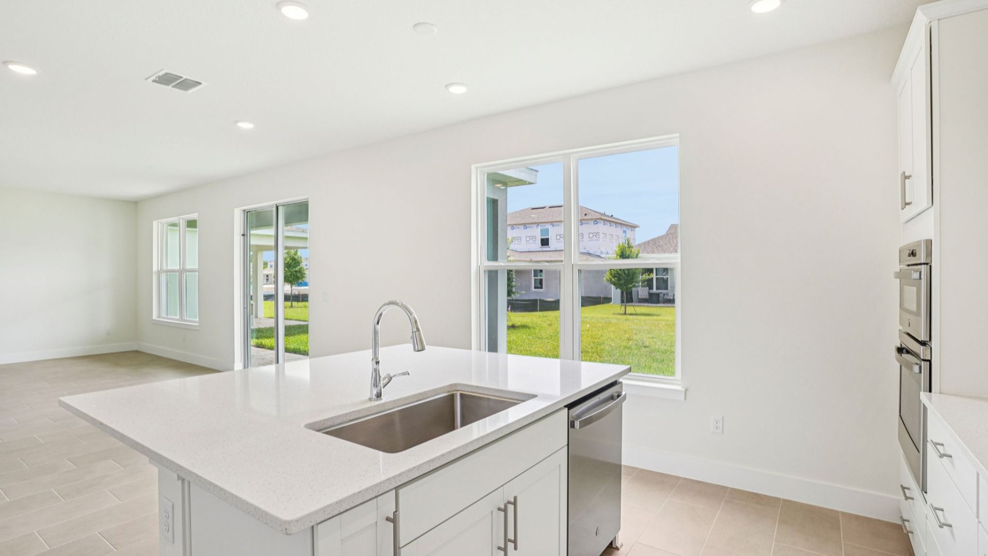 Kitchen sink and quartz island in the Plumeria plan at Lakeside at Satilla by DRB Homes.