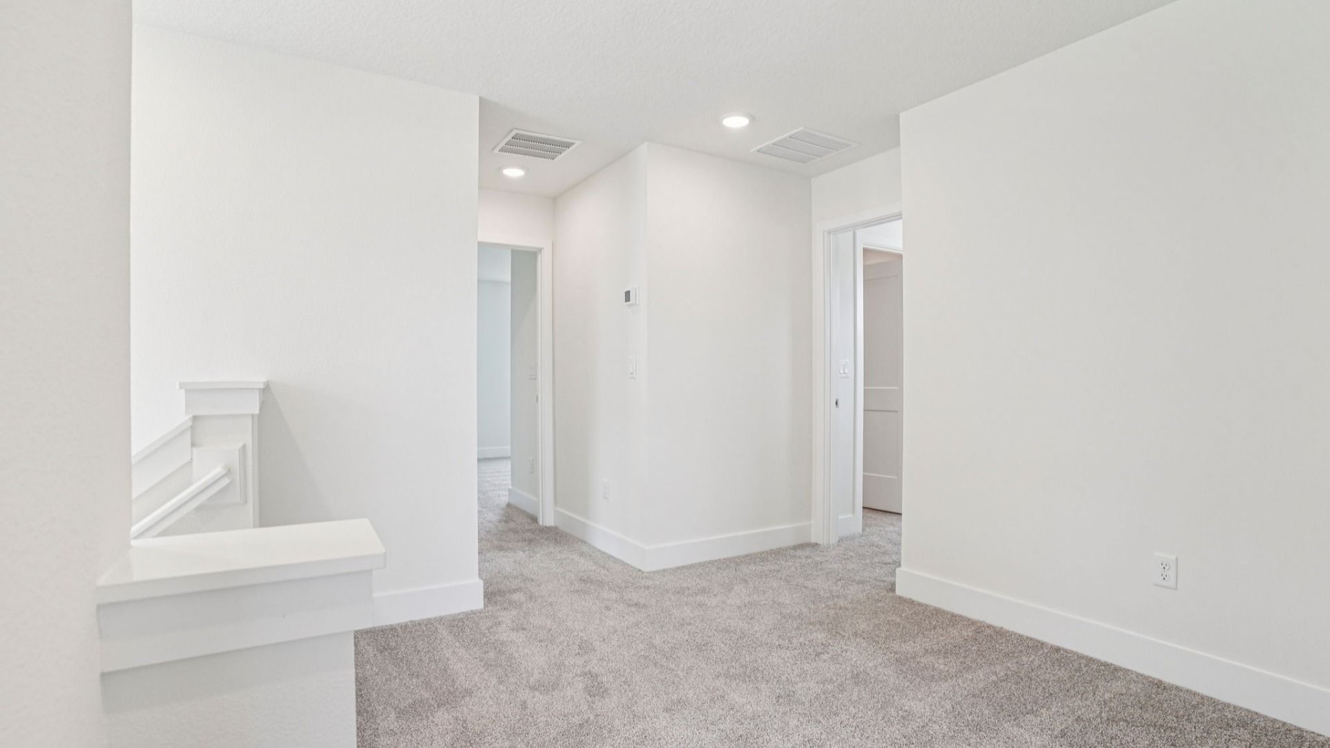 Bright secondary bedroom with carpet in the Plumeria plan at Lakeside at Satilla by DRB Homes.
