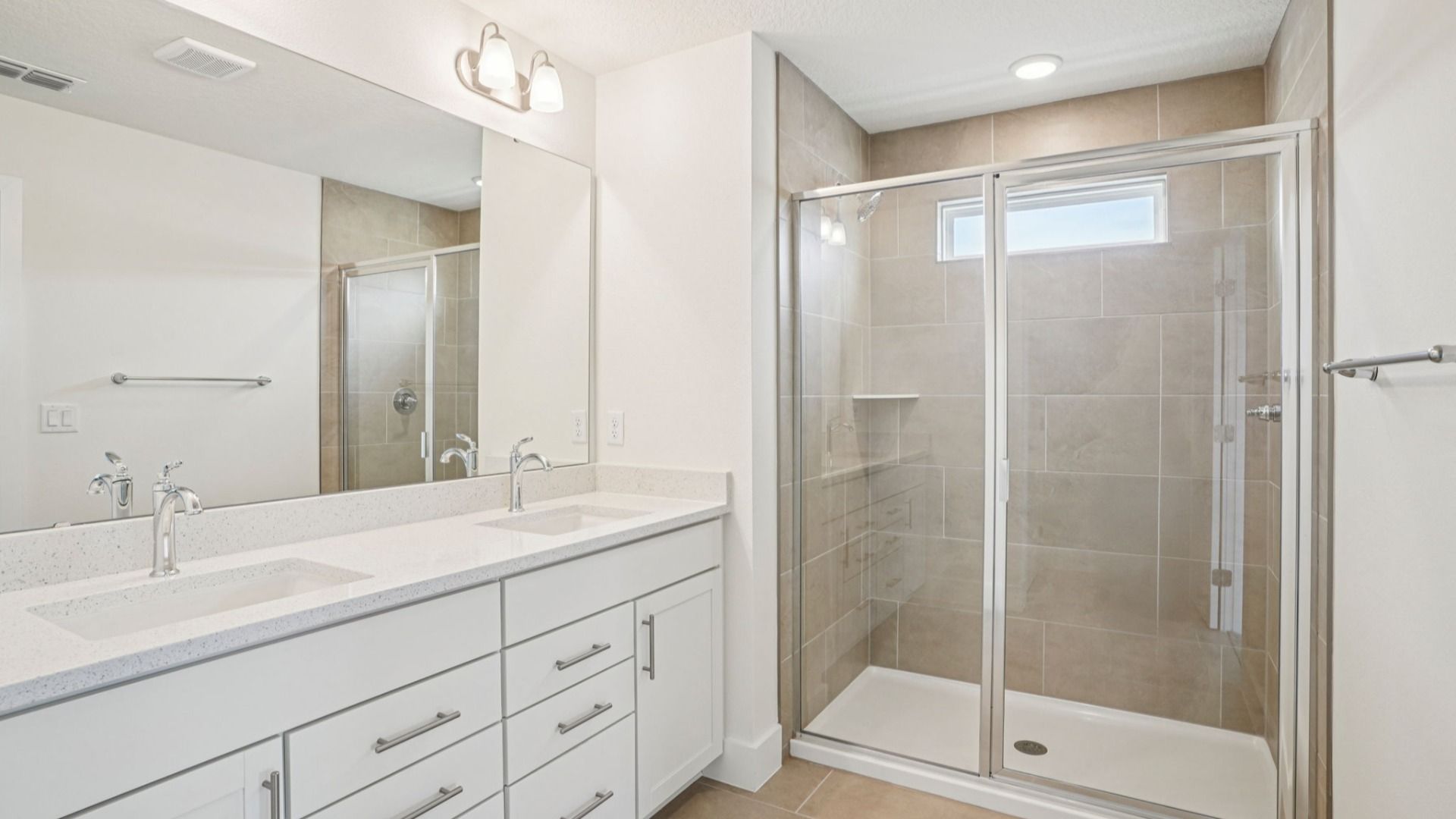 Dual vanity with quartz countertop in the Plumeria plan at Lakeside at Satilla by DRB Homes.