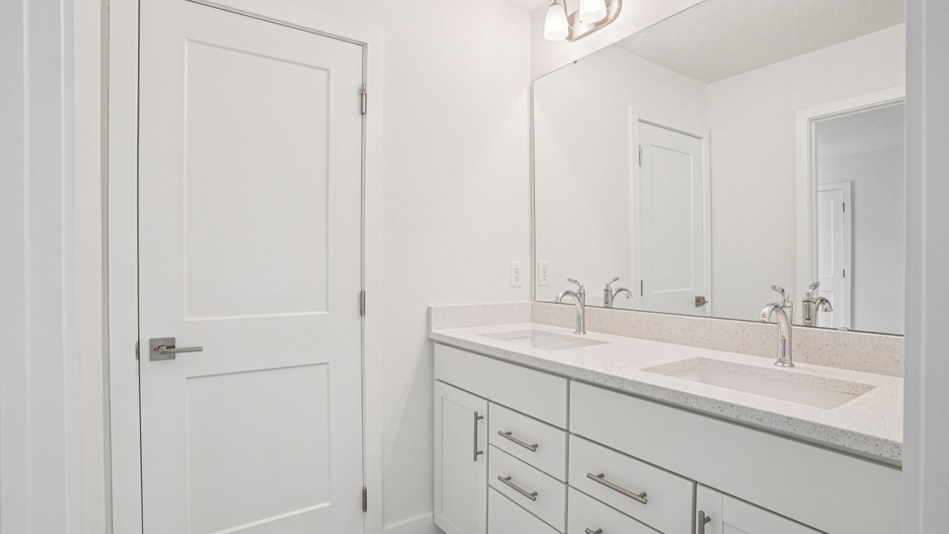 Walk-in shower with glass enclosure and tile in the Plumeria plan at Lakeside at Satilla by DRB Homes.