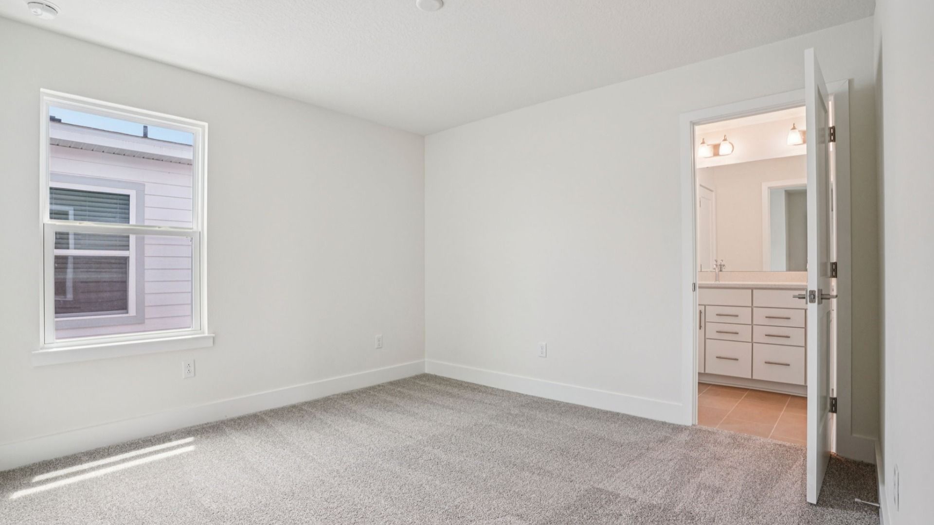 Bedroom with closet in the Plumeria plan at Lakeside at Satilla by DRB Homes.