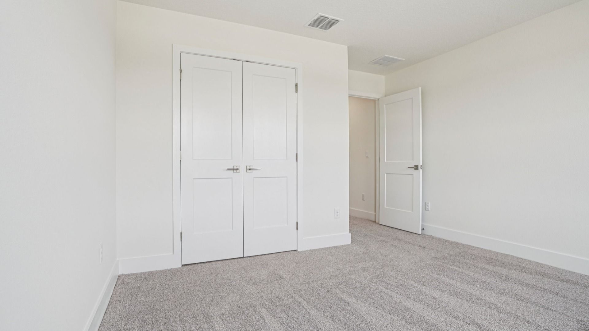 Bedroom with closet in the Plumeria plan at Lakeside at Satilla by DRB Homes.