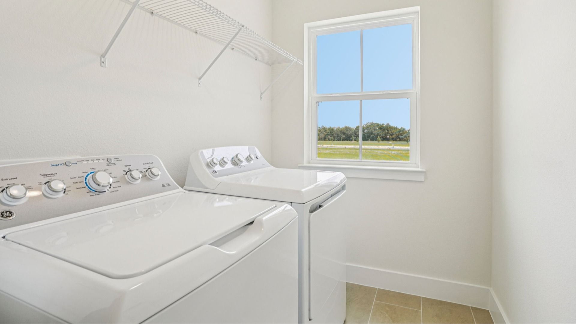 Convenient laundry room with washer and dryer in the Plumeria plan at Lakeside at Satilla by DRB Homes.