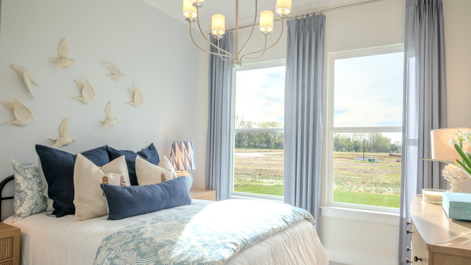 Secondary bedroom with windows and carpet
