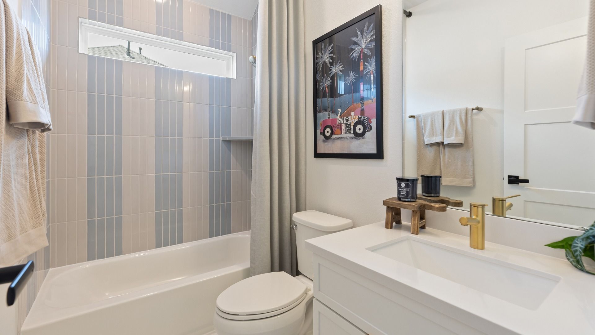 Attached secondary bathroom with blue and cream tile details