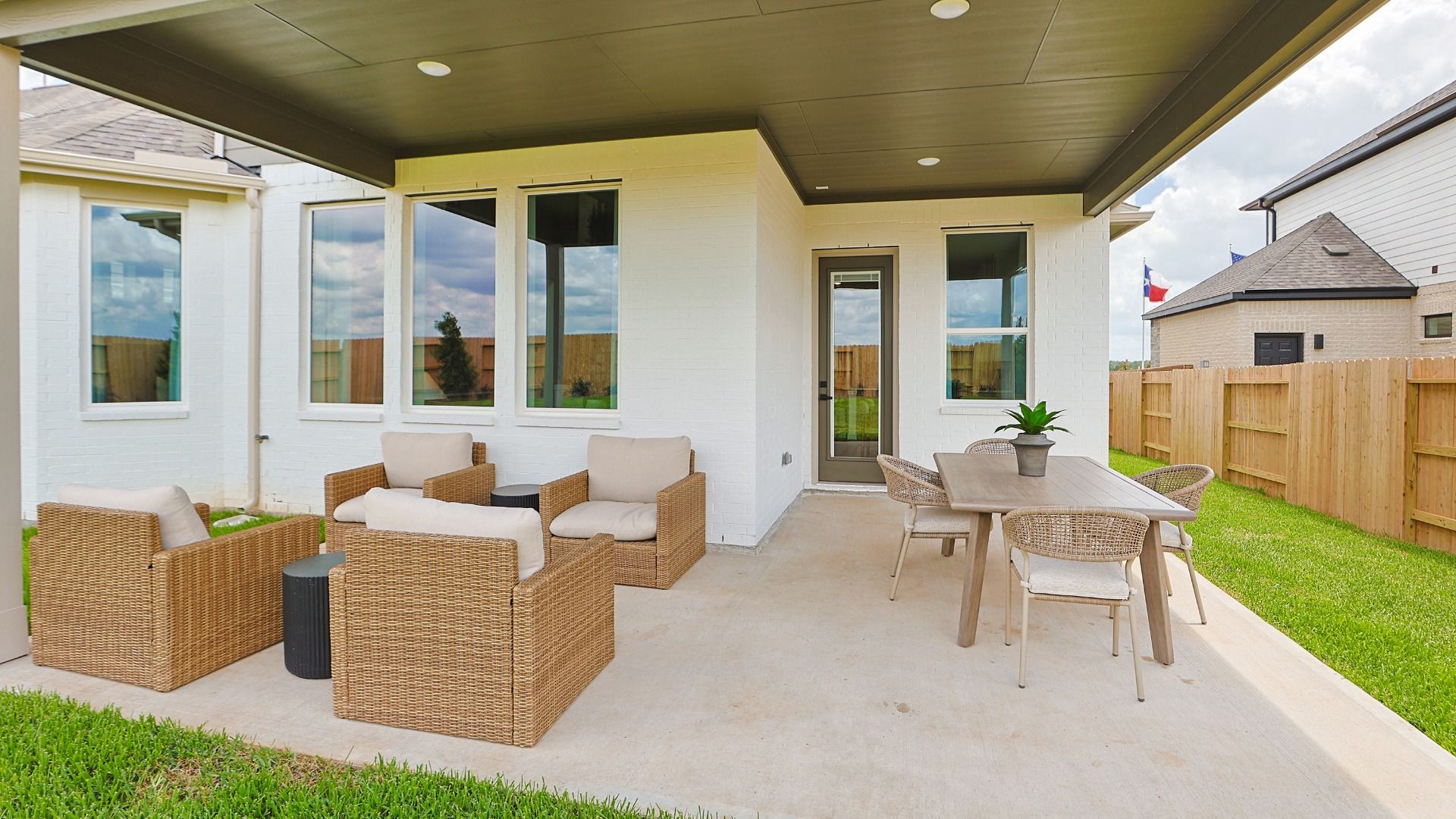 Oversized covered patio with lounging and dining sets for easy outdoor living.