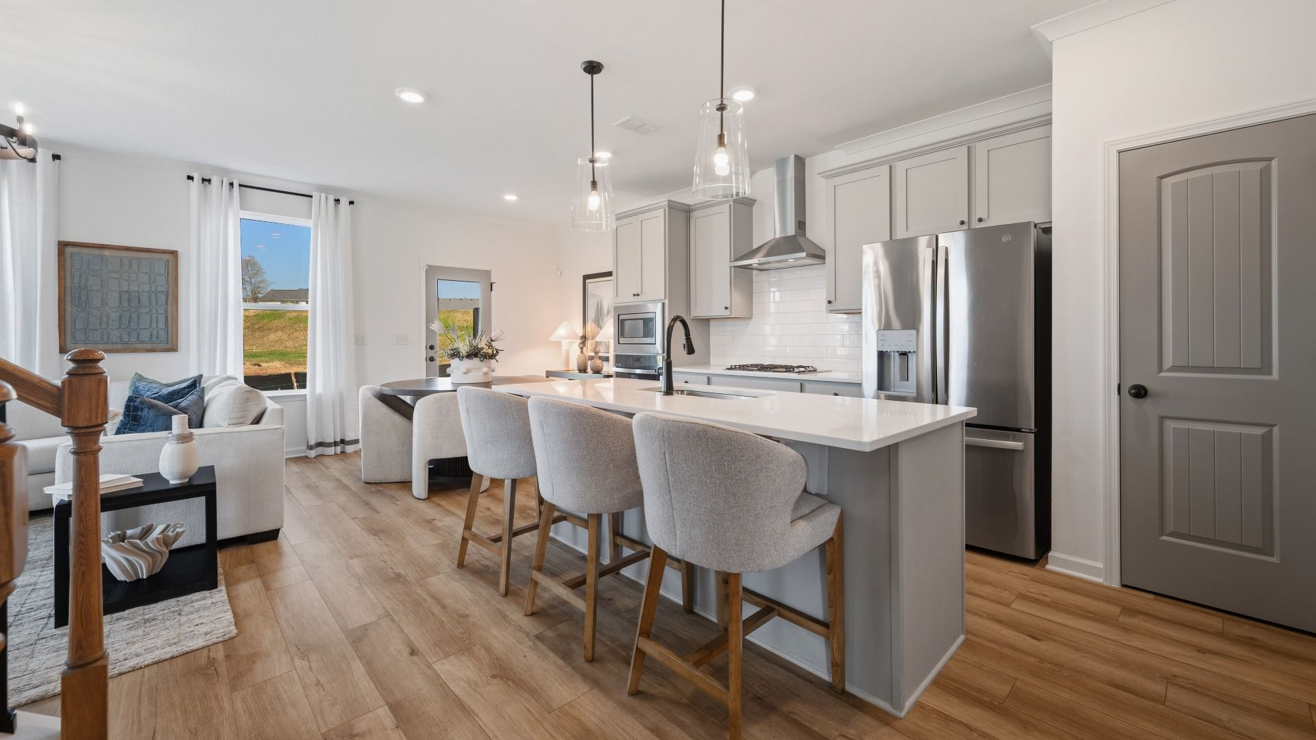 Kitchen with pendant lighting, tile backsplash, and quartz countertops