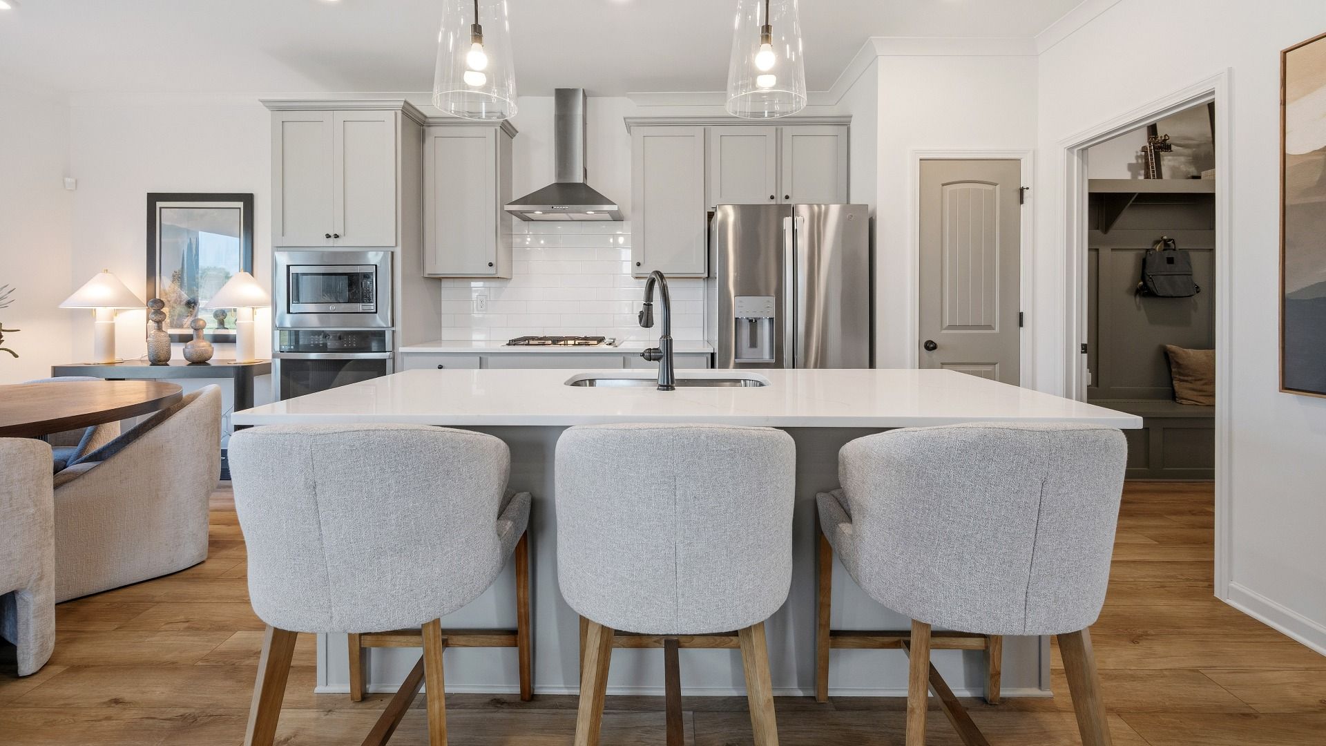 Kitchen with pendant lighting, tile backsplash, and quartz countertops