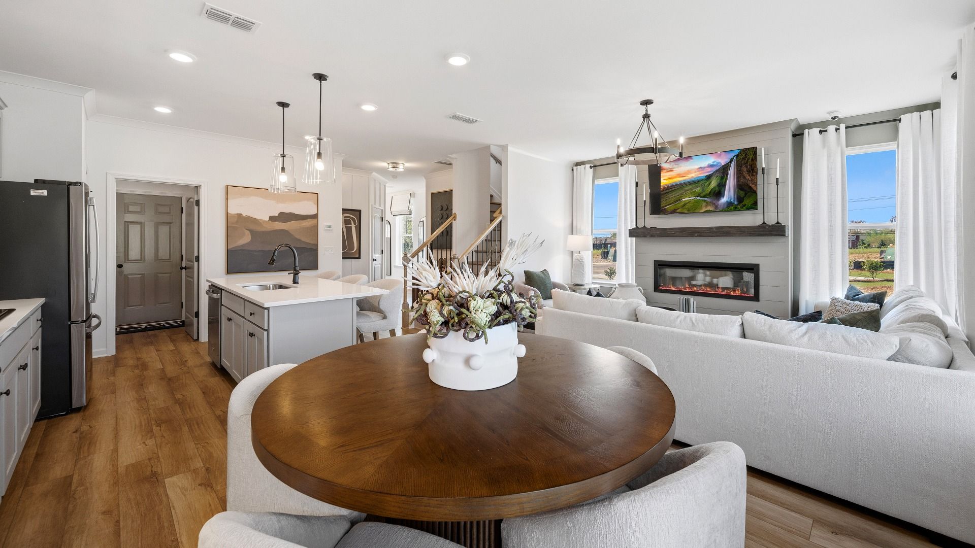 View of gathering area and kitchen from dining area