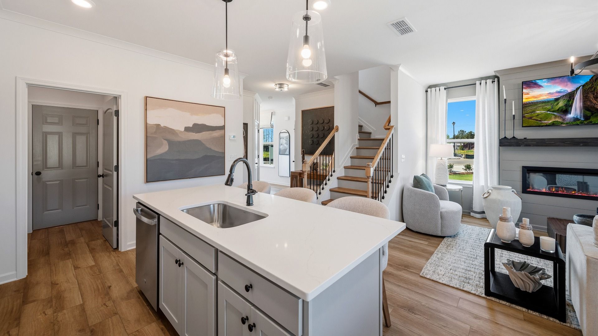 First floor kitchen area with view of gathering room and staircase