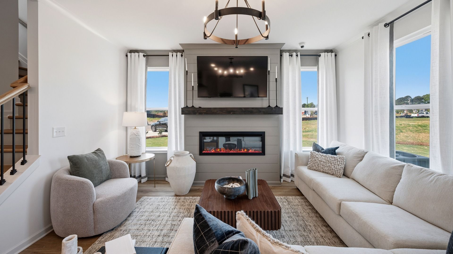 Gathering room with large windows, fireplace, and hard surface flooring