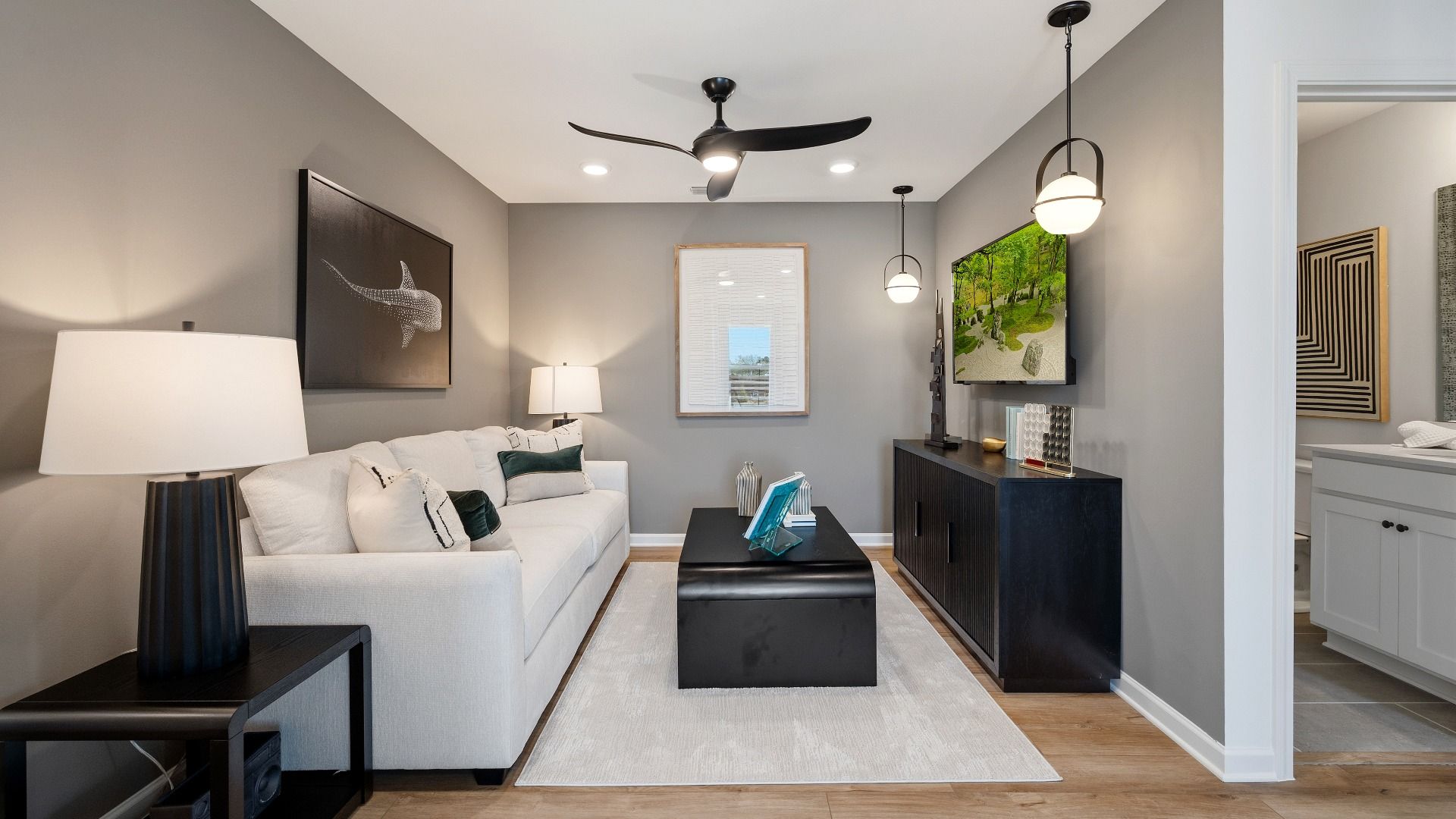 Loft area with ceiling fan and hard surface flooring
