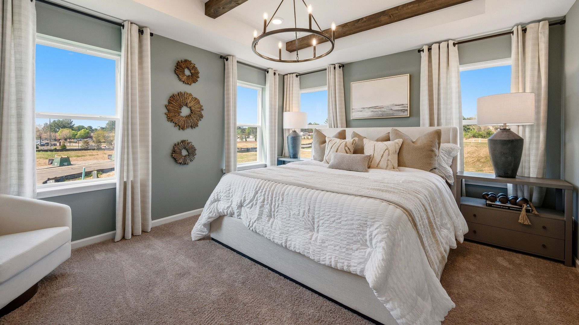 Bedroom with tray and accent ceiling, carpet and windows