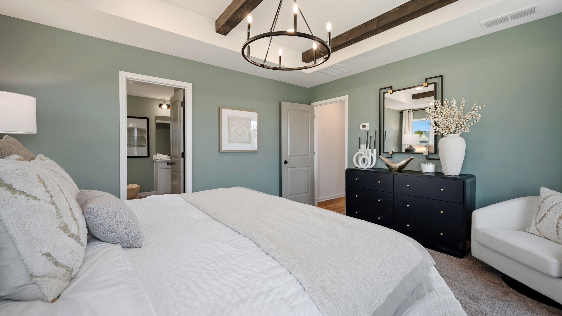 Bedroom with tray and accent ceiling, carpet and windows
