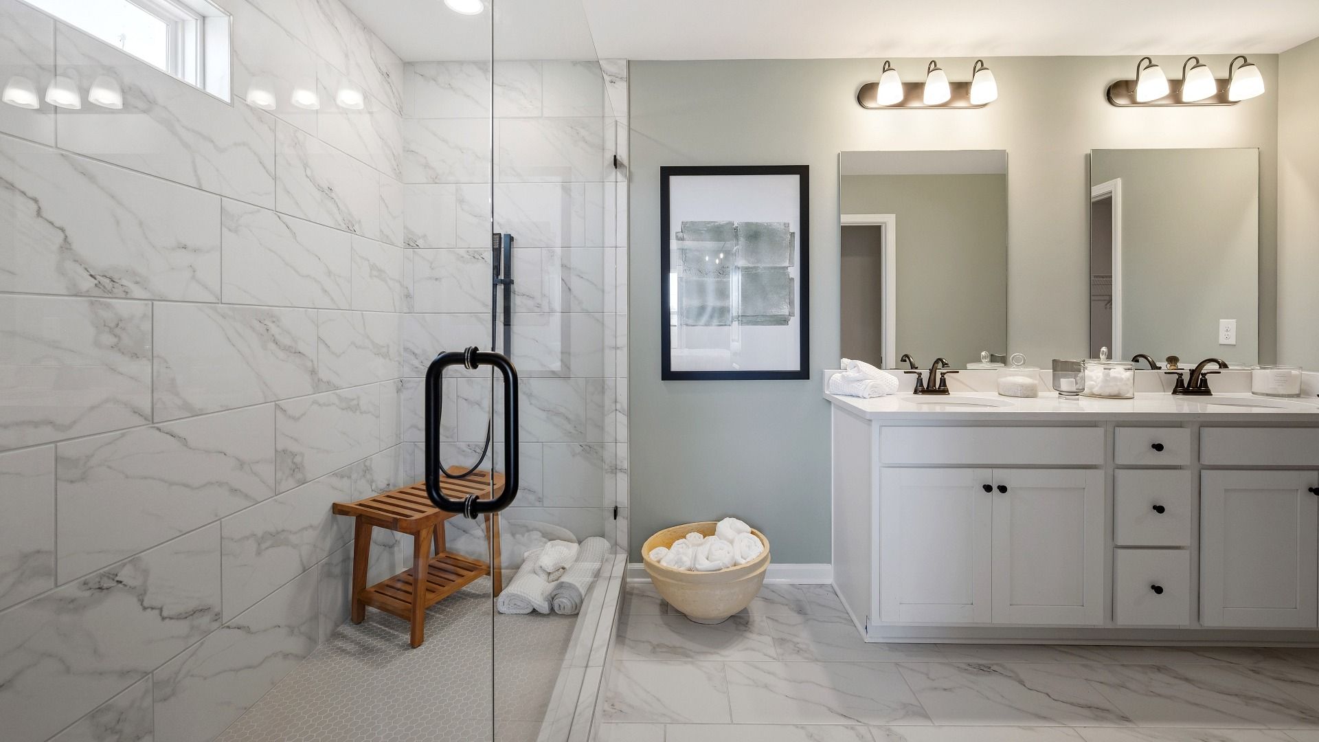 Bathroom with spacious glass enclosed shower with a shower window