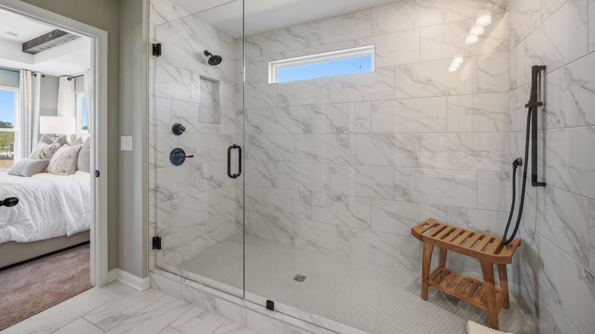 Bathroom with spacious glass enclosed shower with a shower window