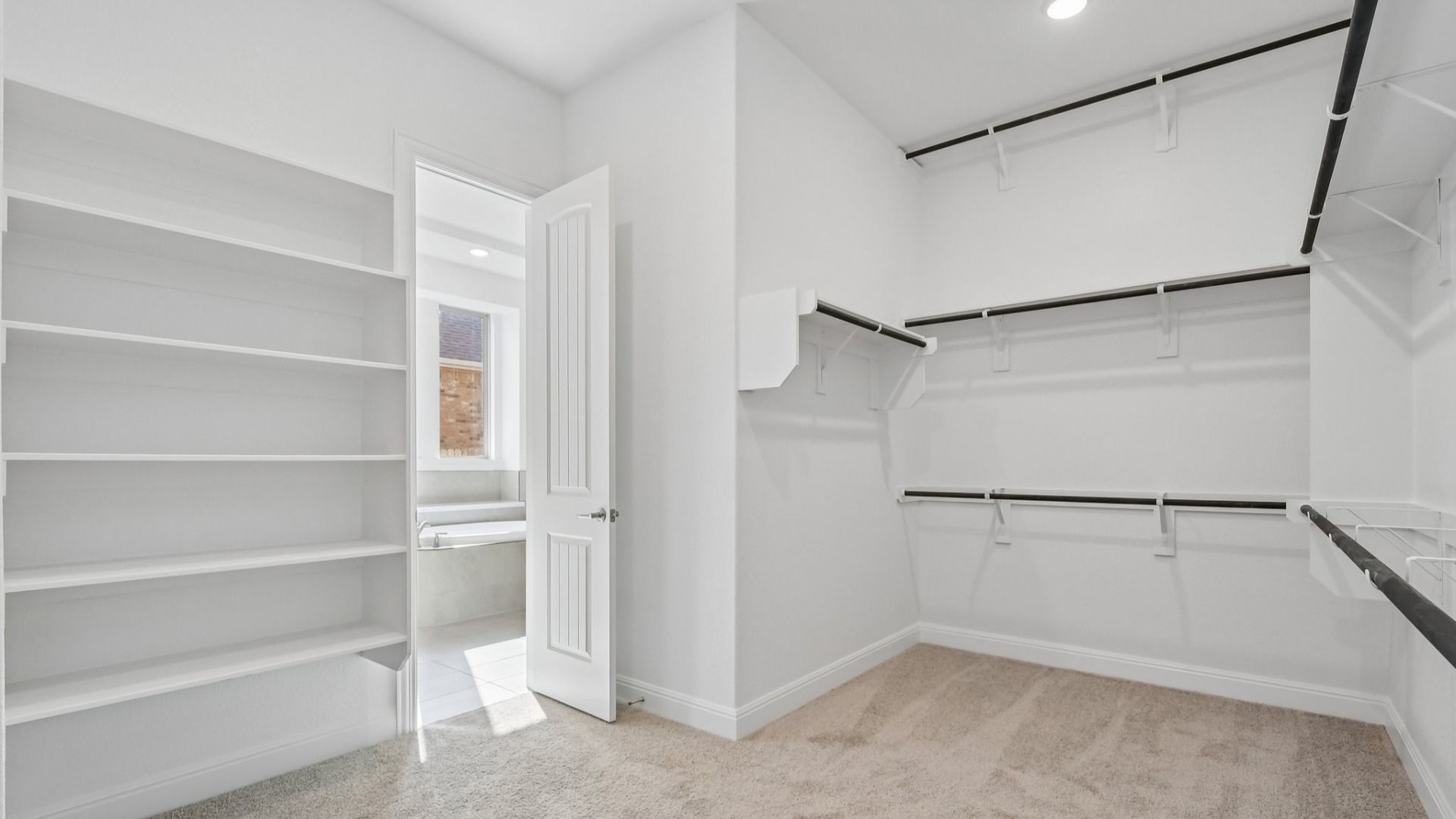 The walk-in closet in the Primary Bedroom of the Brown floorplan at Retreat at San Gabriel - Representative Image