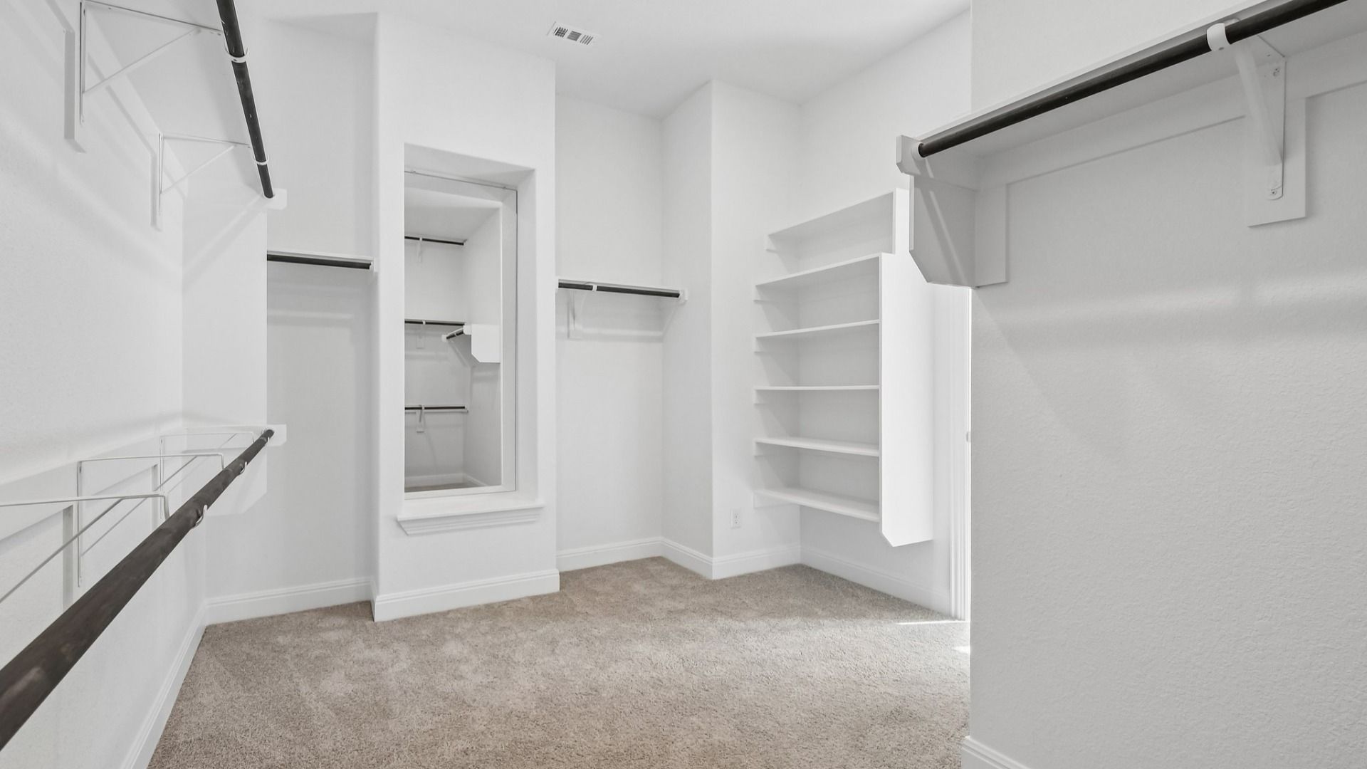 The walk-in closet in the Primary Bedroom of the Brown floorplan at Retreat at San Gabriel - Representative Photo