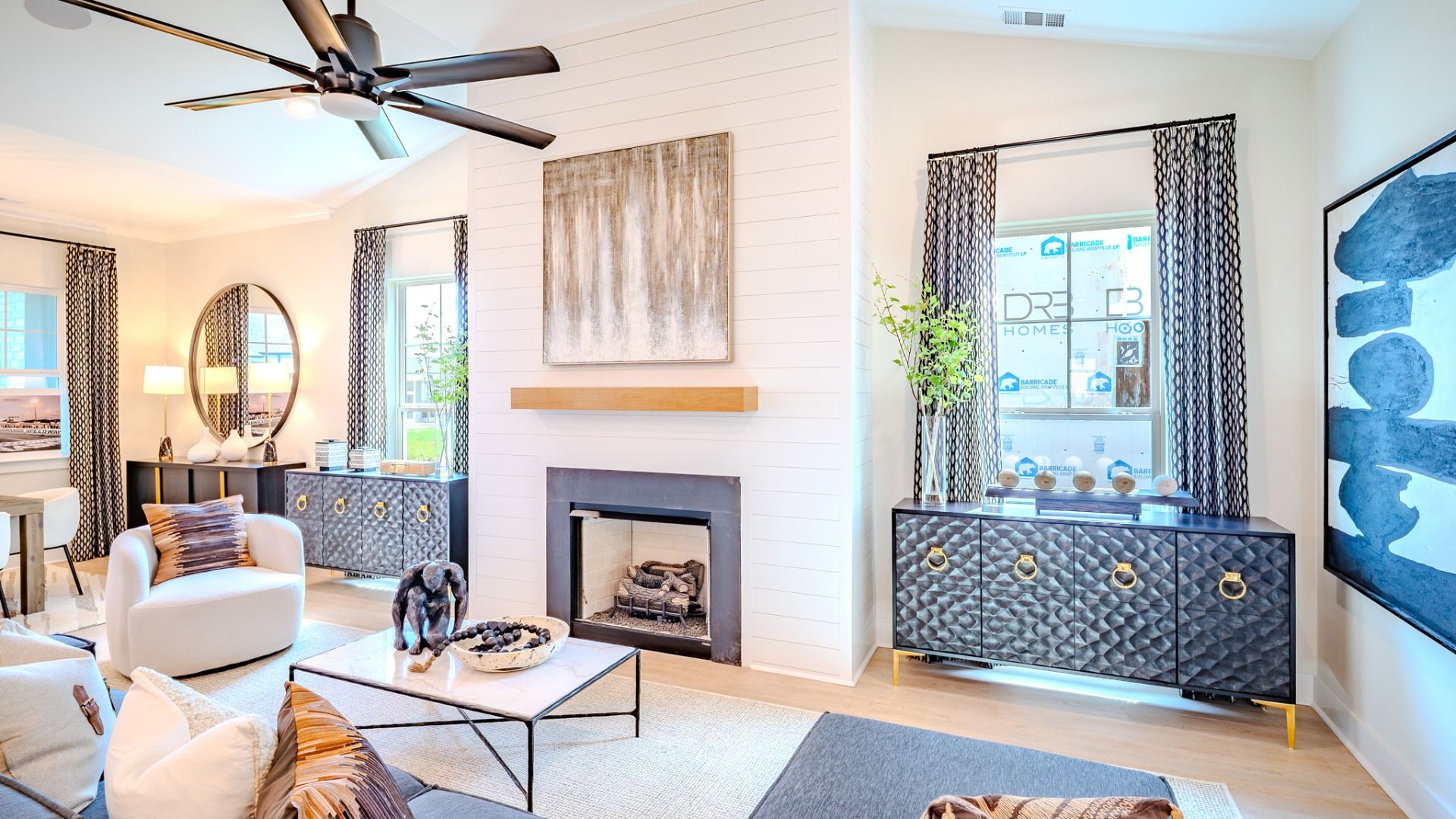 Gathering area with high ceilings, ceiling fan, and fireplace