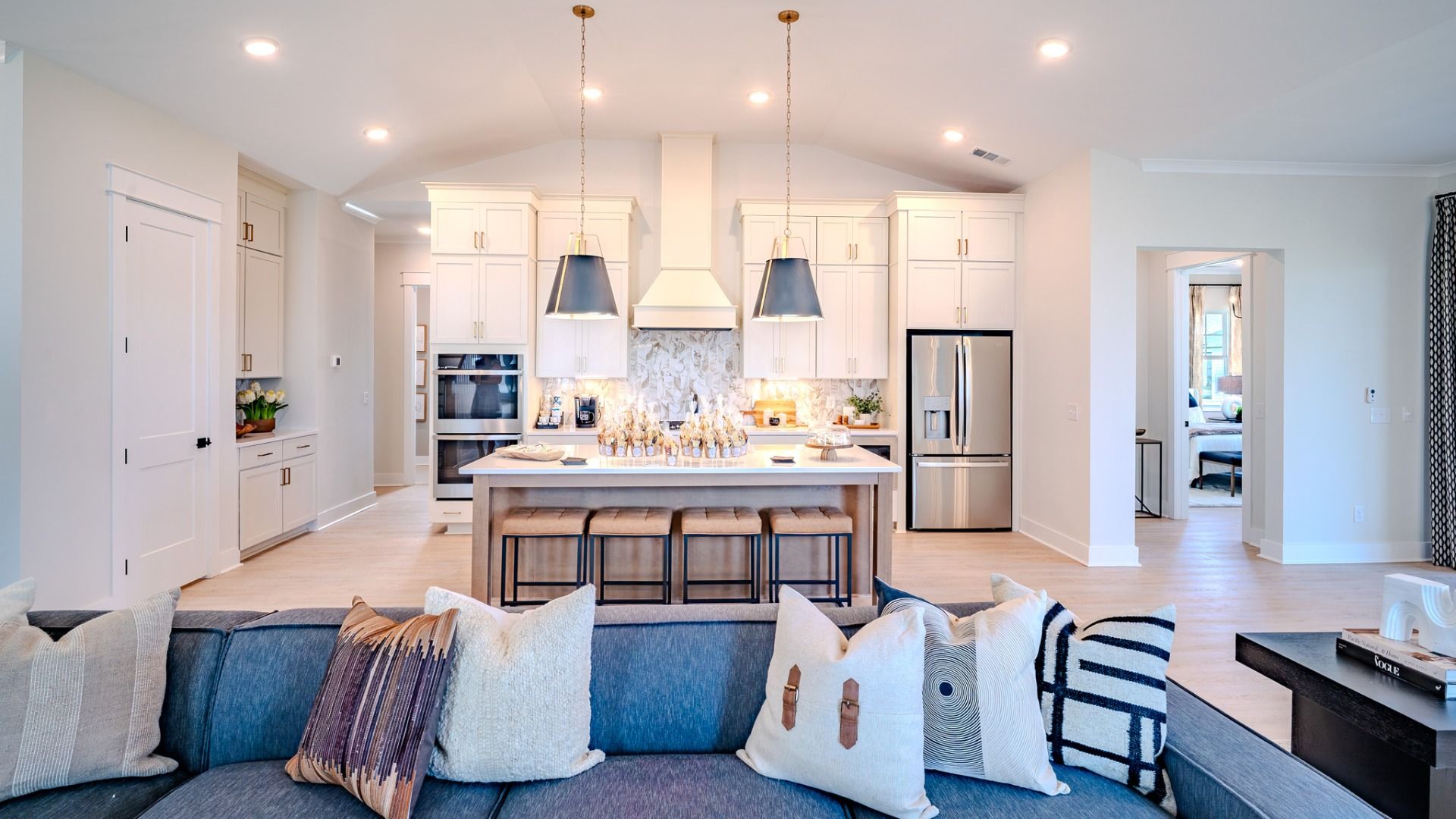 Kitchen with light cabinetry, quartz countertops, and tile backsplash