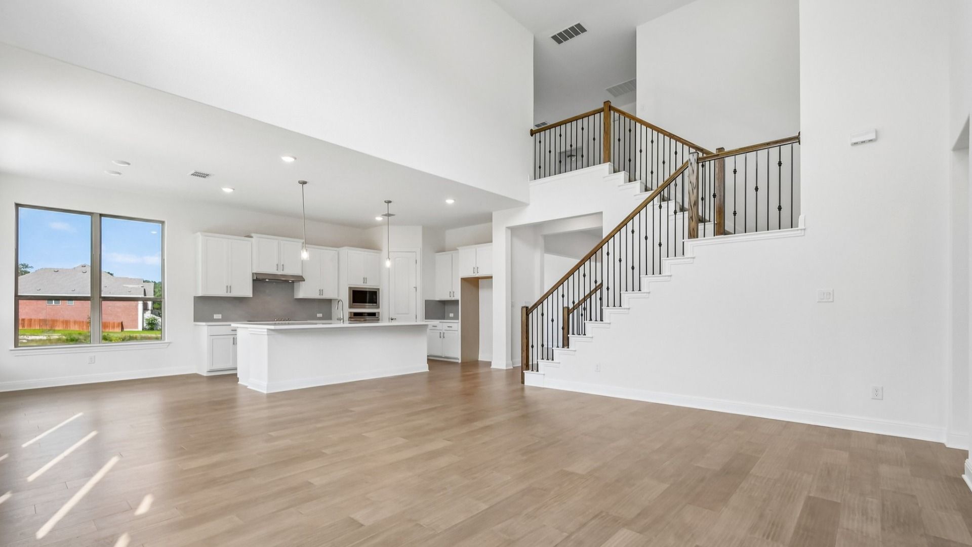 An interior shot of the living room/kitchen in the Brown floorplan at Retreat at San Gabriel - Representative Image