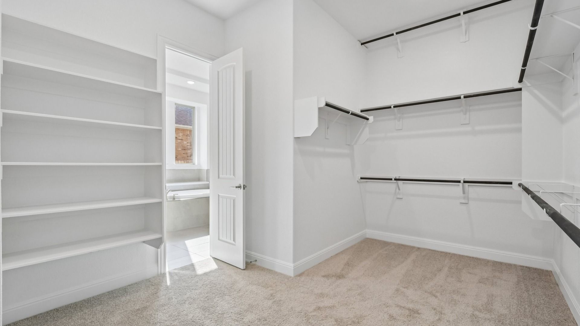 The walk-in closet in the Primary Bedroom of the Brown floorplan at Retreat at San Gabriel - Representative Image