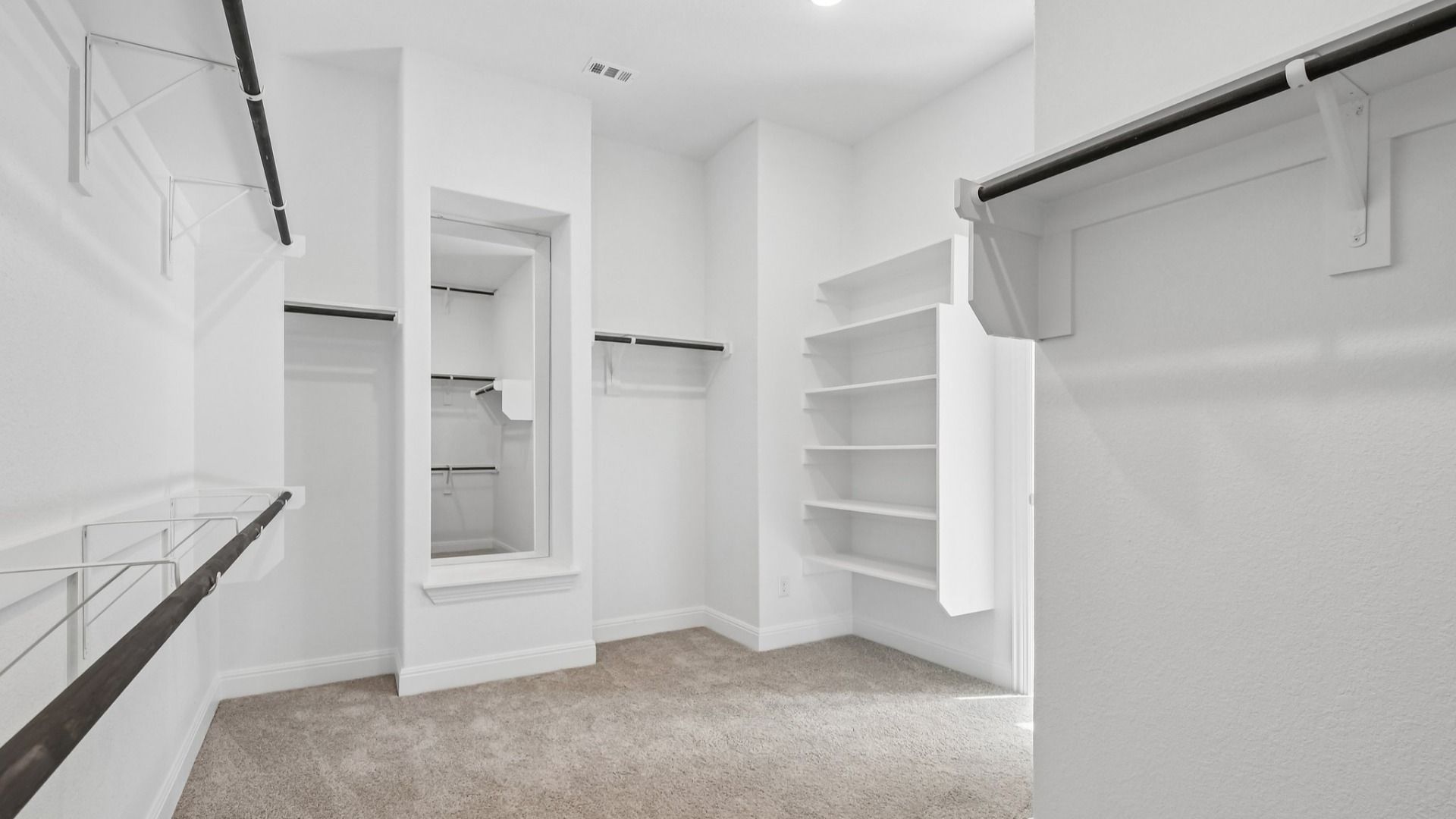 The walk-in closet in the Primary Bedroom of the Brown floorplan at Retreat at San Gabriel - Representative Image