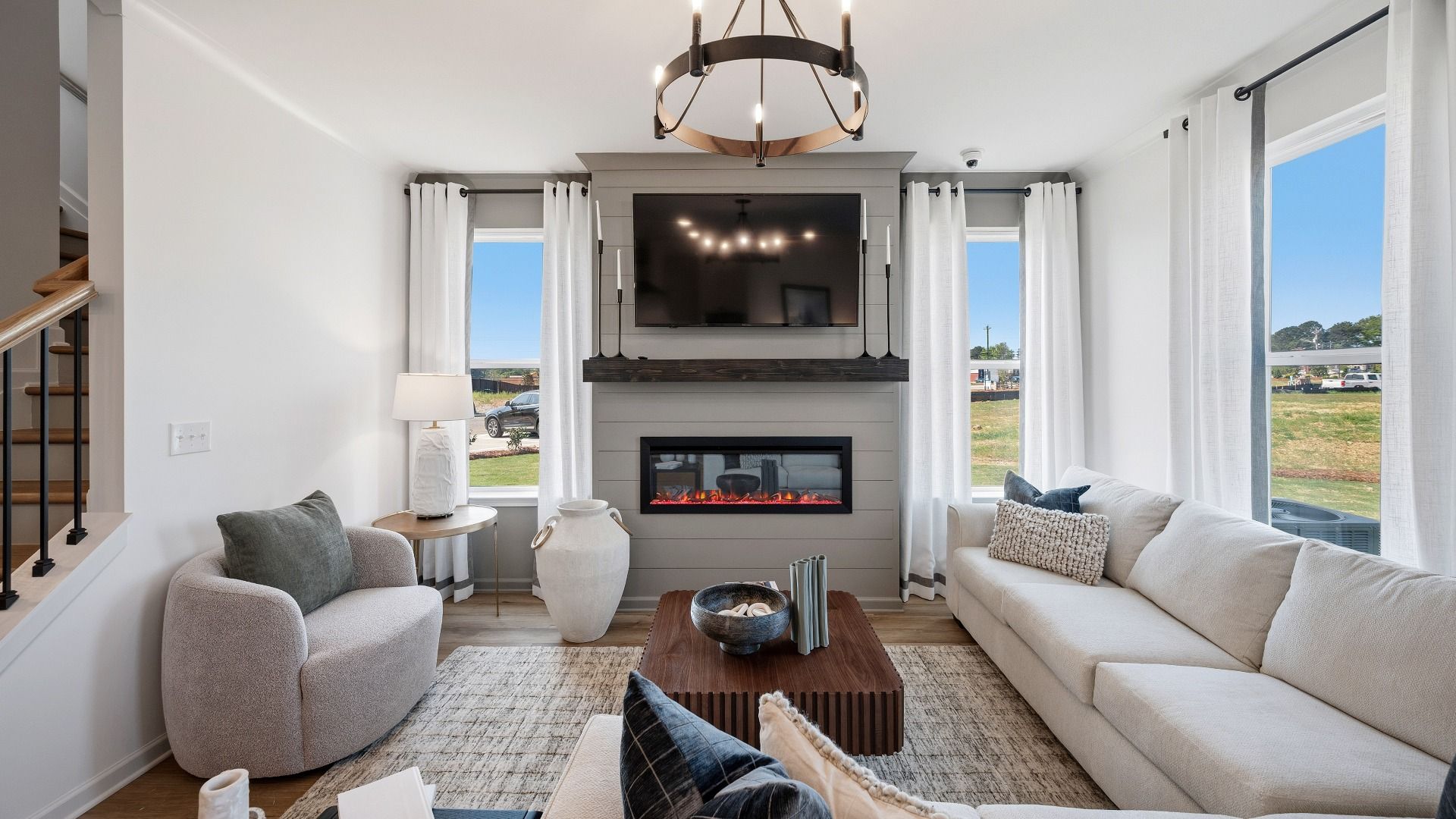 Gathering room with natural bright light from windows, hard surface flooring, and fireplace