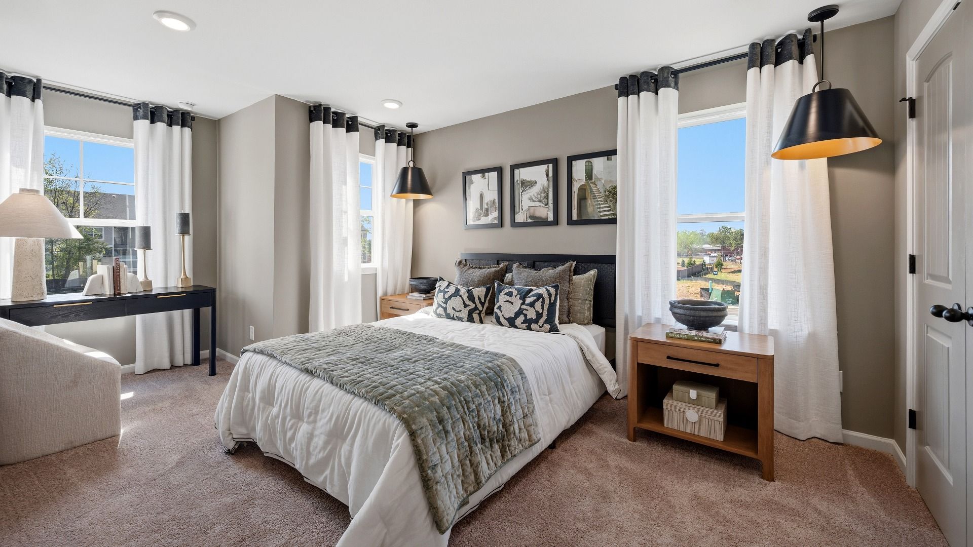 Secondary bedroom with bright natural lighting from windows, carpet, and closet