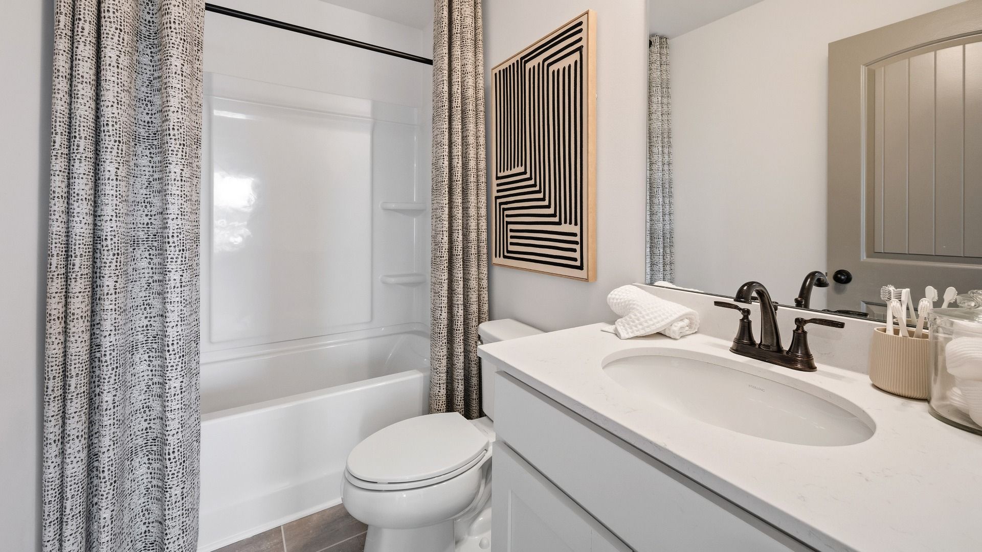 Spacious secondary bathroom with shower, toilet, and single vanity