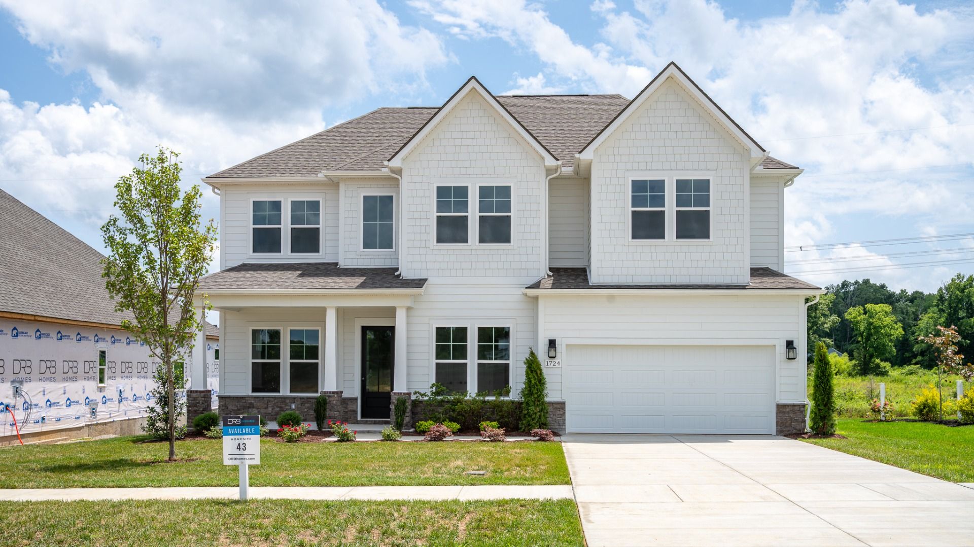 Grace II plan exterior with stone water table and brilliant white siding