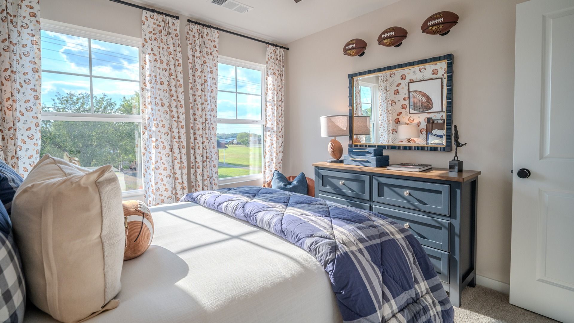 Secondary bedroom with carpet and windows