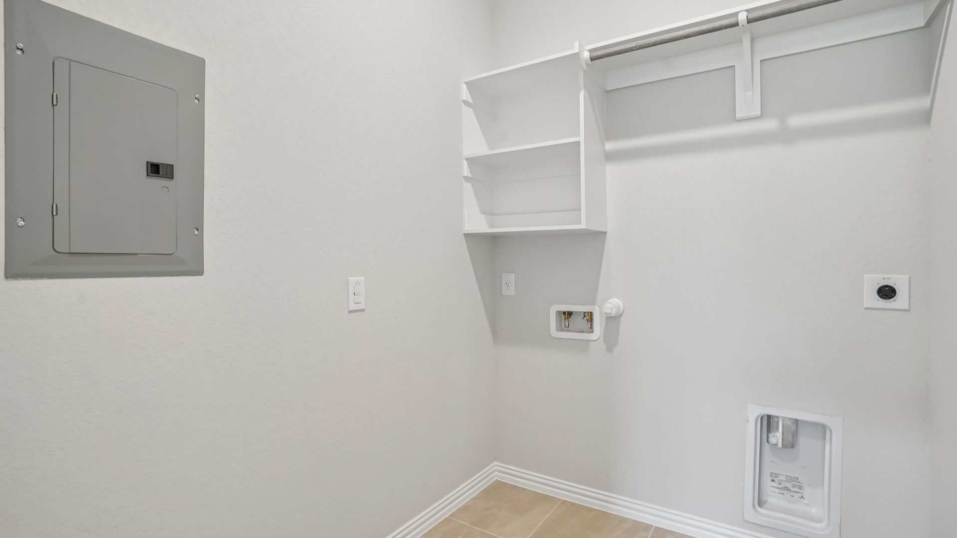 Full Sized Utility Room with Built-In Shelving and Wooden Clothing Rod