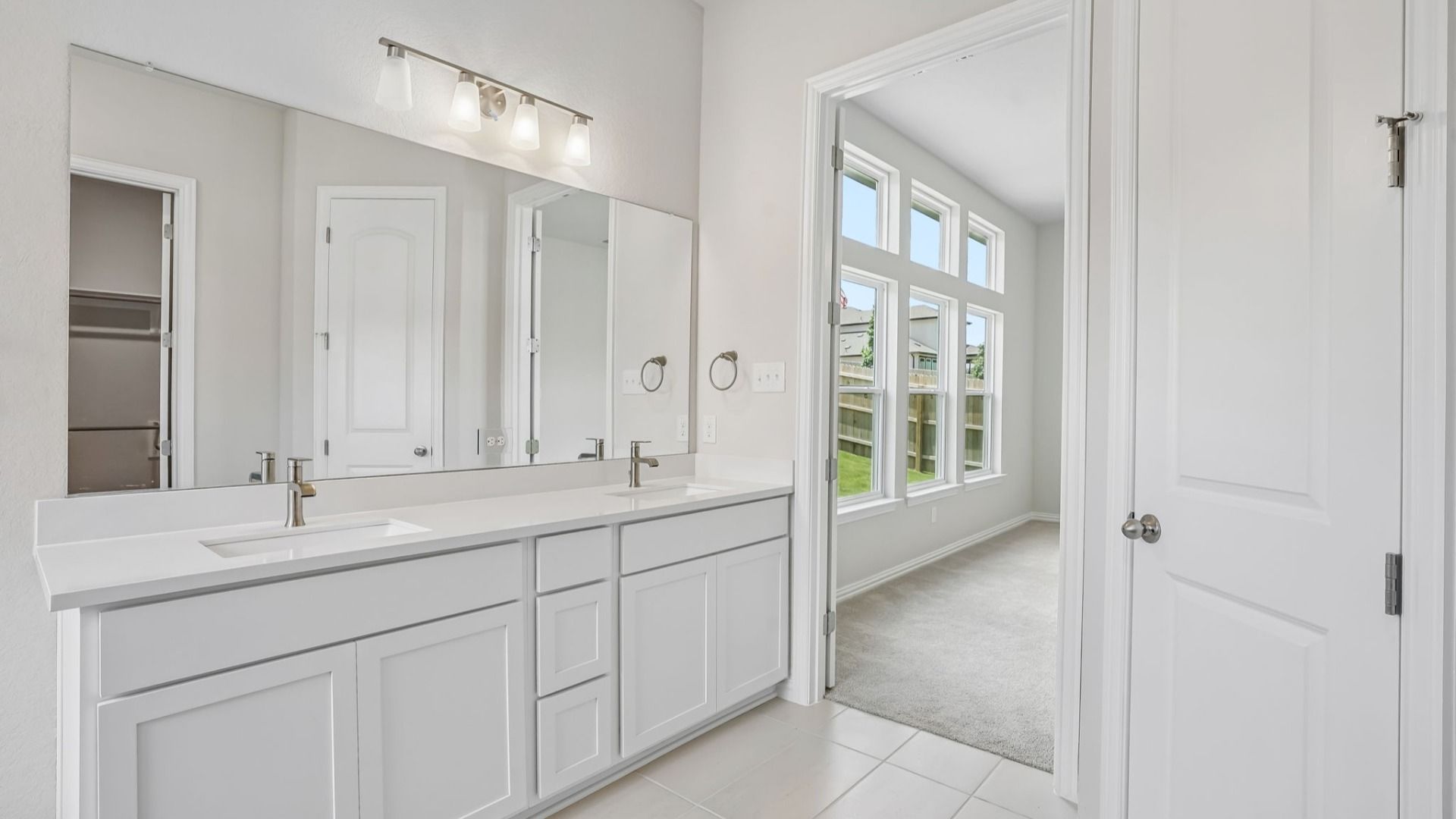 Luxurious owner's bath featuring a picture window, garden tub, glass shower & dual vanity.