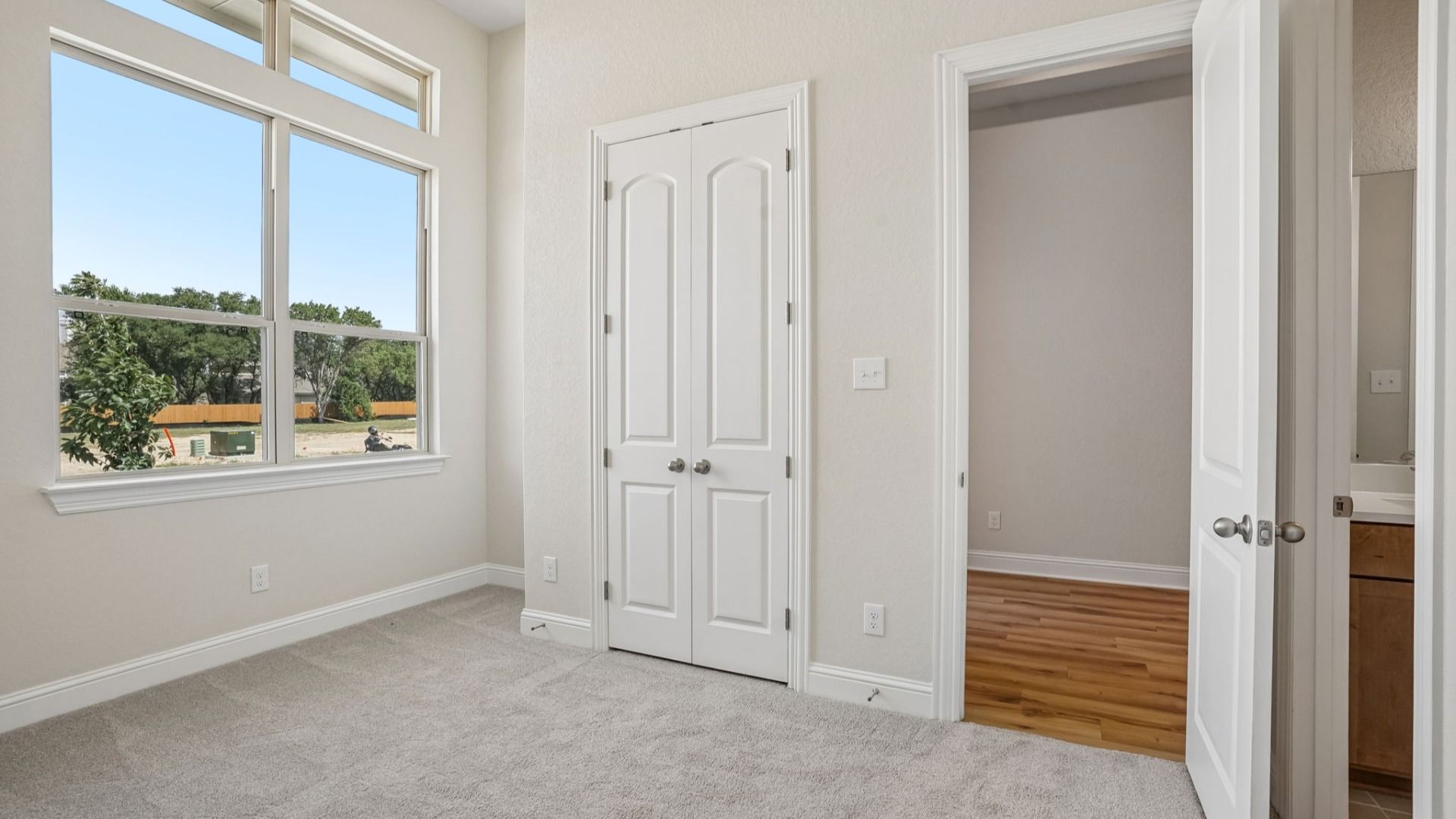 Secondary Room with an abundant of natural lighting and shared bath attached