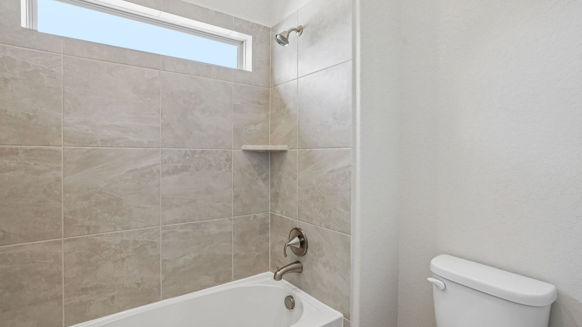 Secondary Bath Shower/Tub combo has a window for natural lighting