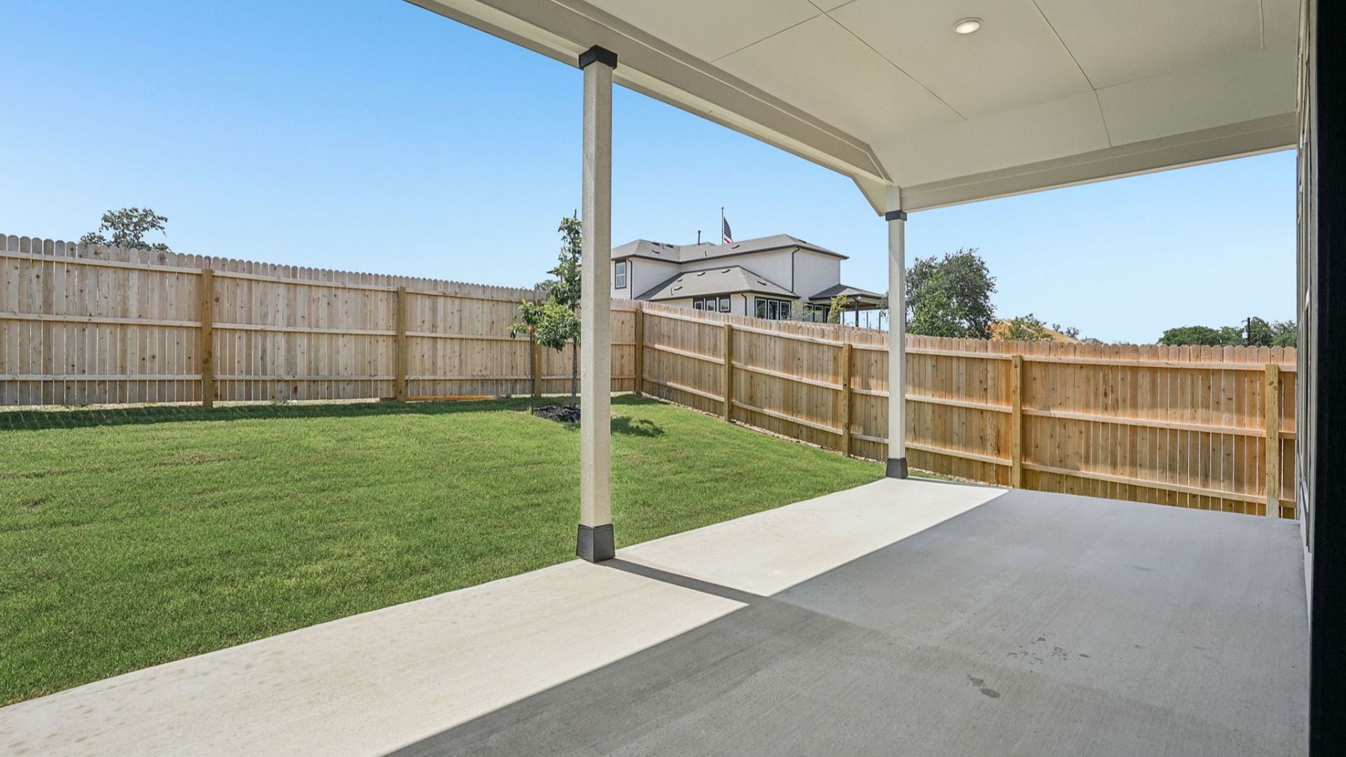Inviting covered patio with peaceful backyard views.