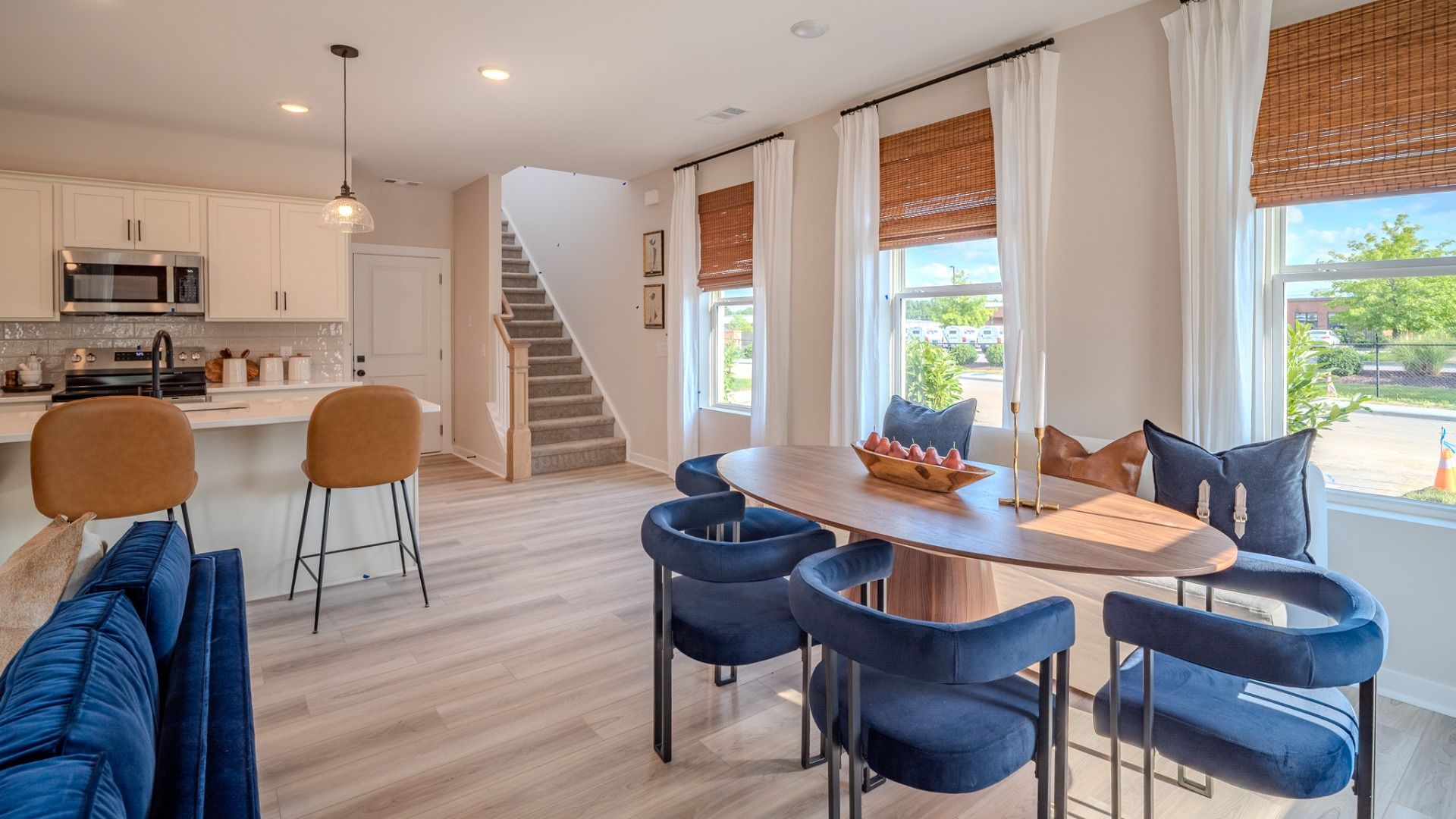 View of dining area, kitchen, and access to staircase